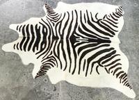 A Faux Zebra Rug 7 feet 3 inches x 5 feet 7 inches.