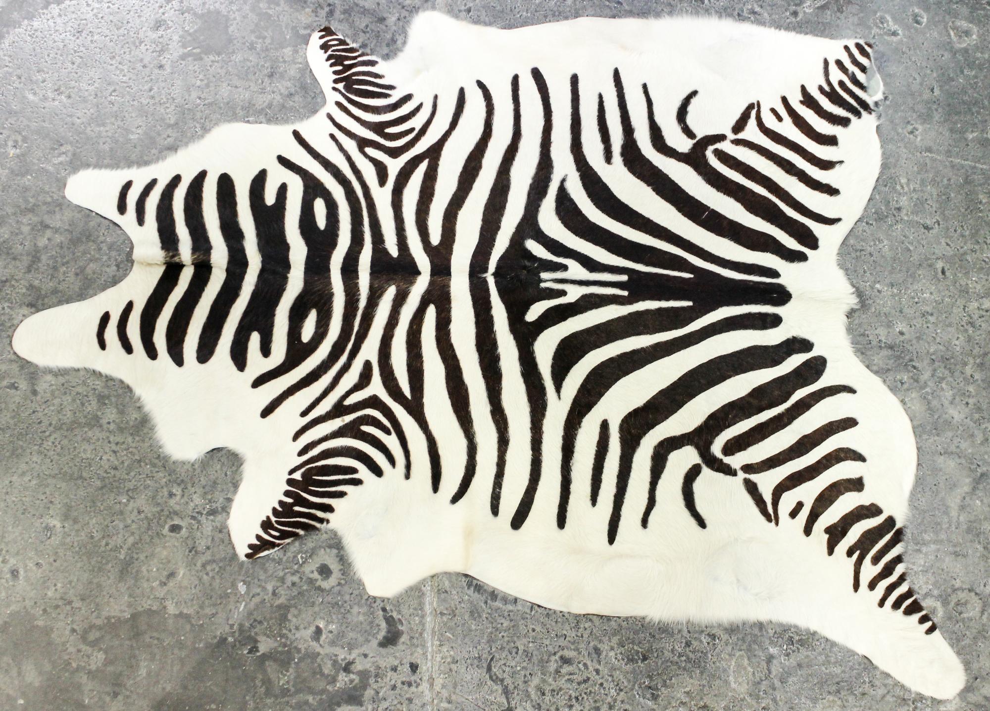 A Faux Zebra Rug 7 feet 3 inches x 5 feet 7 inches.
