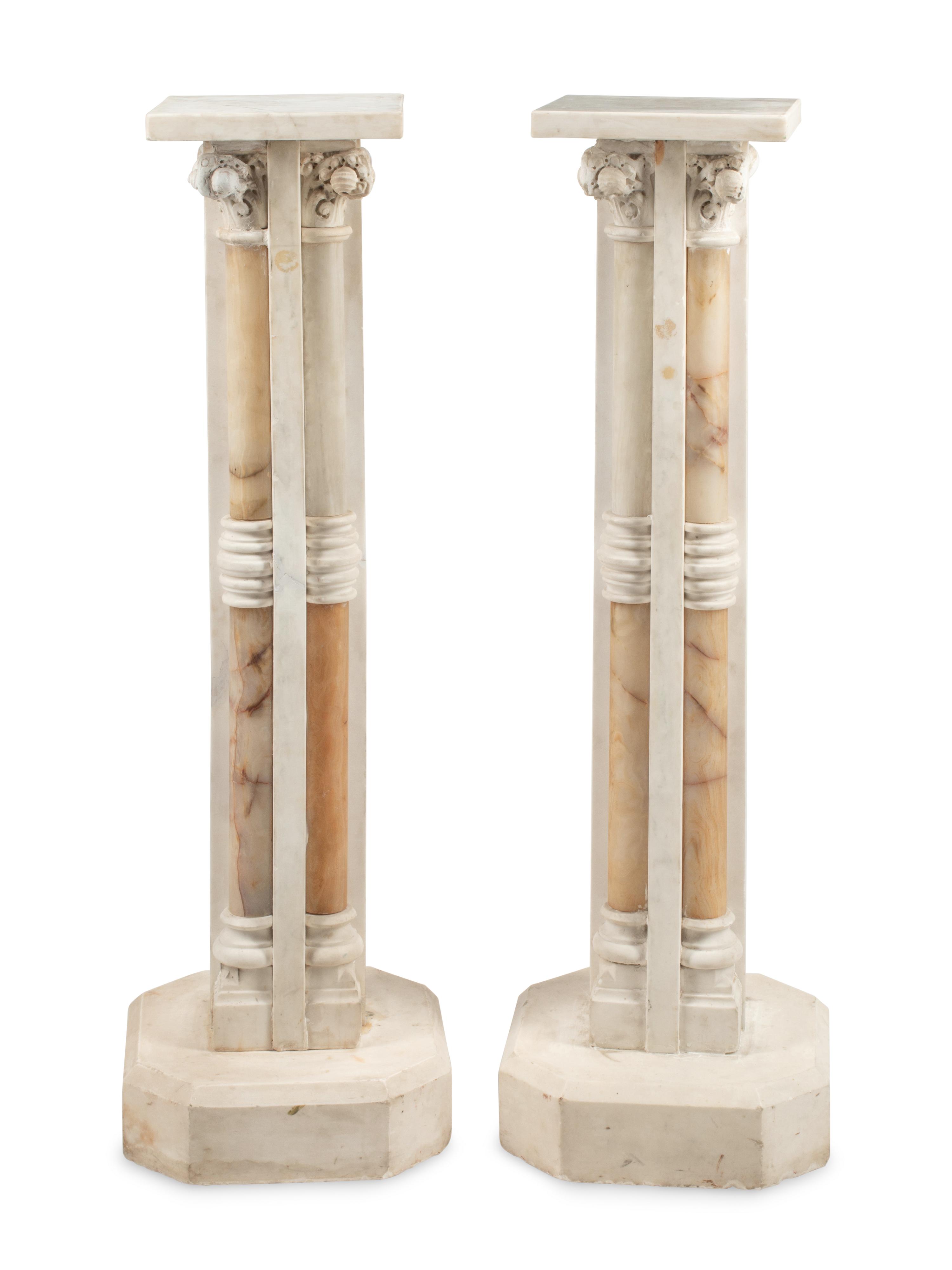 A Pair of Continental Carved Marble and Onyx Quadripartite Pedestals