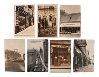 [EARLY PHOTOGRAPHY]. A group of 42 real photo postcards of cityscapes, town activities and disasters, parades, circuses, and fairs, highlighted by view of a child labor protest, an elephant parade, and bronco busting.