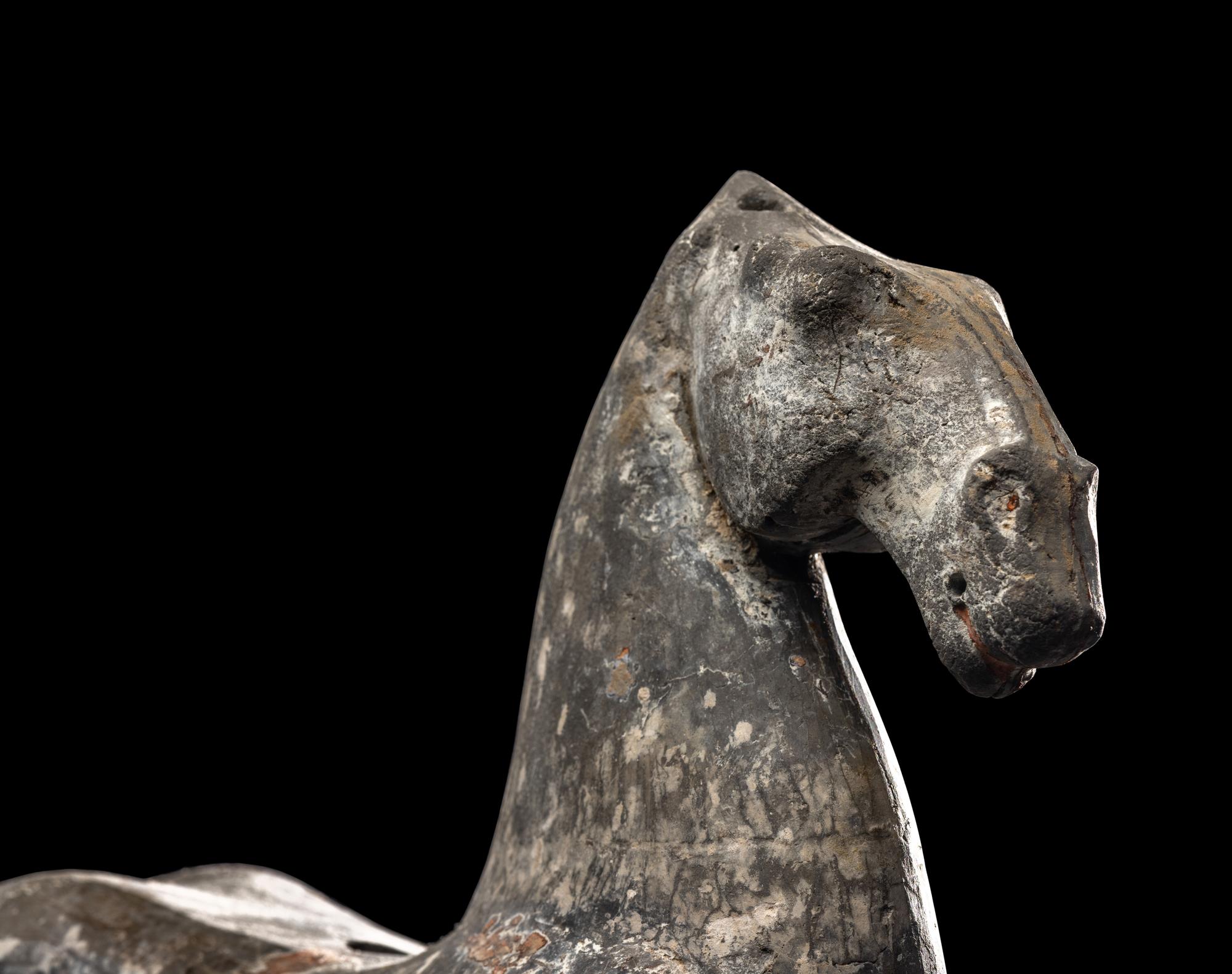 A Chinese Grey Pottery Figure of a Recumbent Horse
