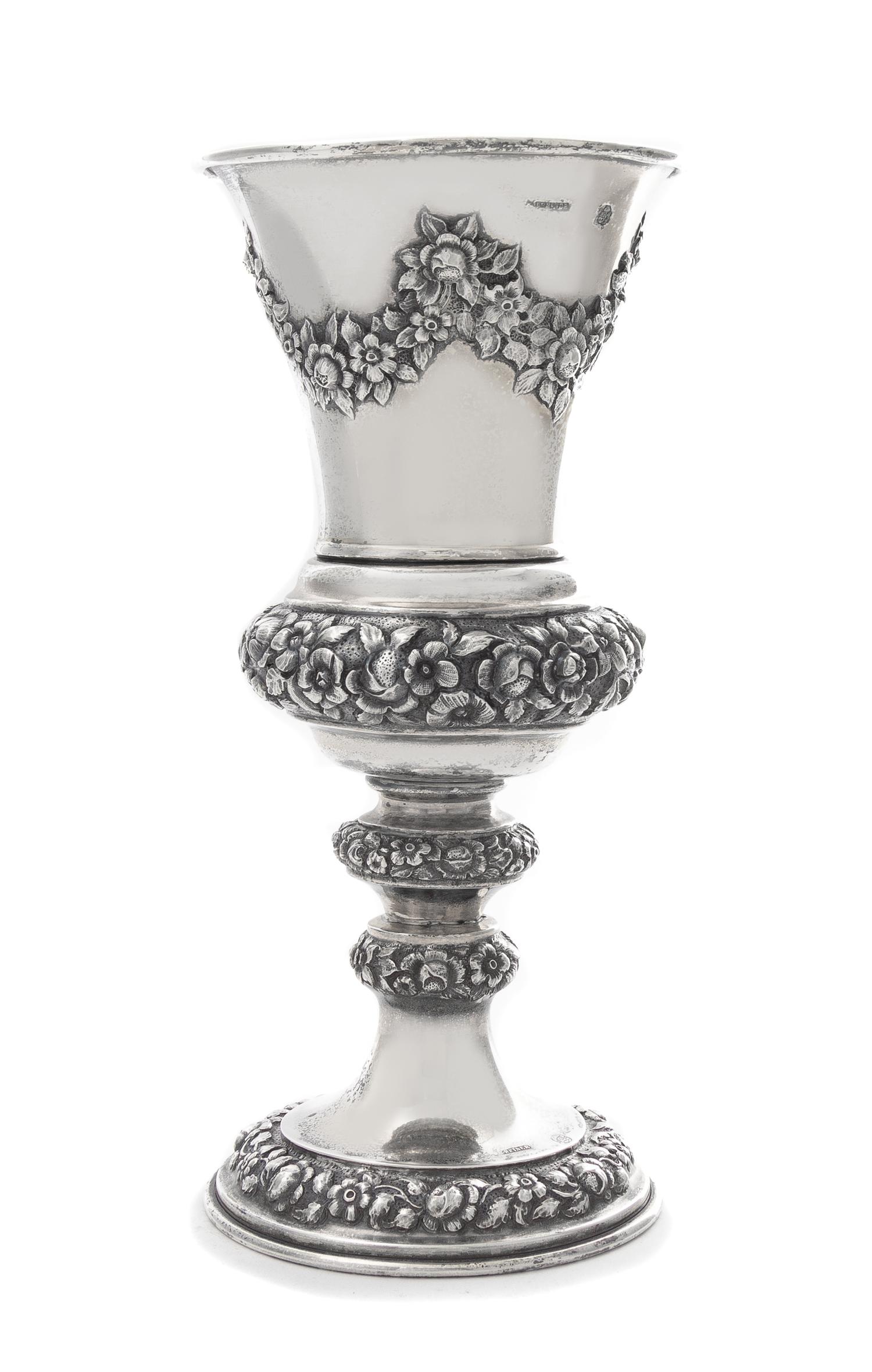 An Austrian Silver Chalice, J. Reiner, Vienna, 1847, the tapering cup worked to show repousee floral swags, raised on a similarly decor