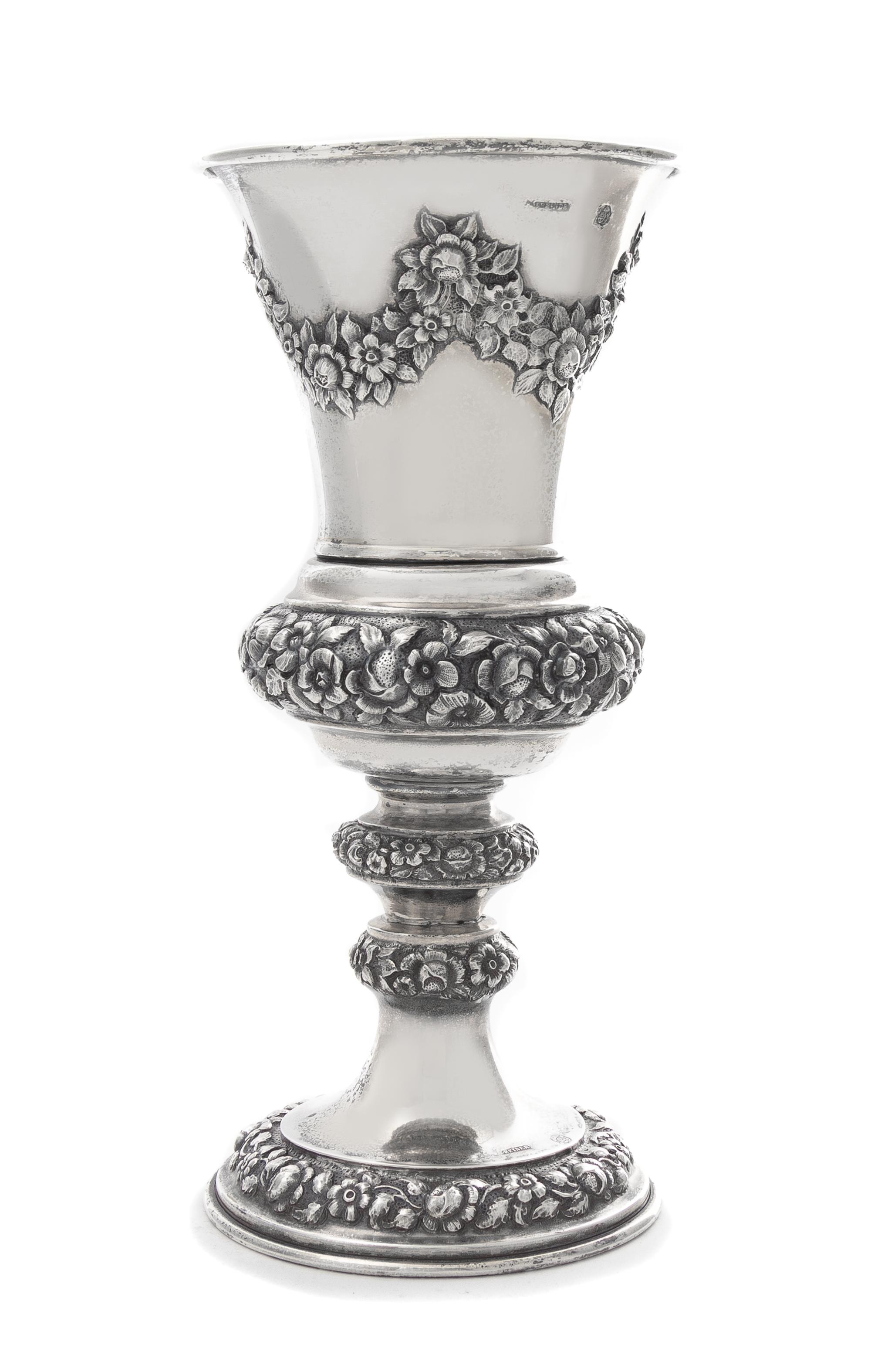 An Austrian Silver Chalice, J. Reiner, Vienna, 1847, the tapering cup worked to show repousee floral swags, raised on a similarly decor