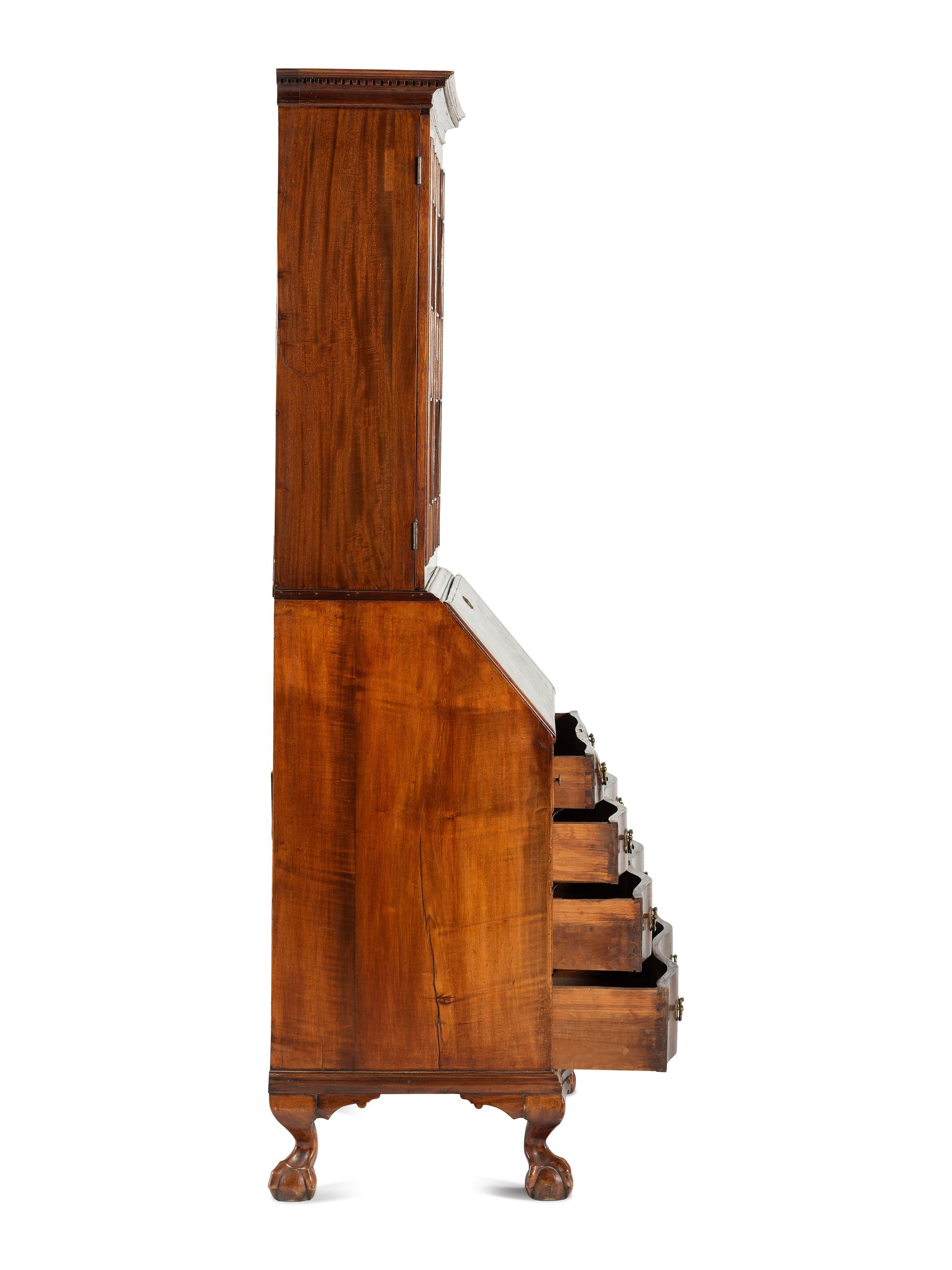 A Chippendale Mahogany and Cherrywood Serpentine Claw-and-Ball Foot Desk-and-Bookcase