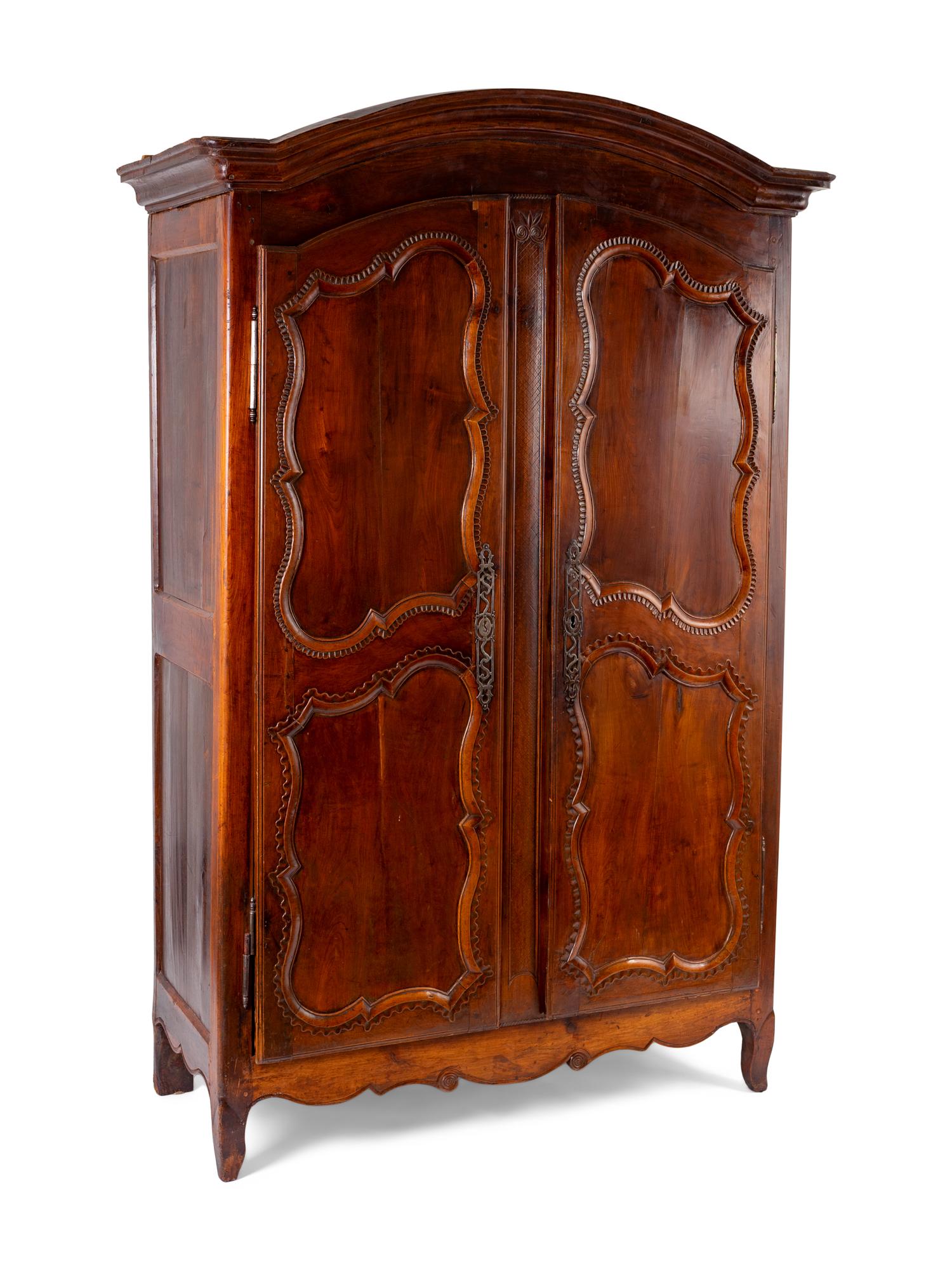 A French Provincial Carved Walnut Armoire — 19TH CENTURY