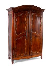 A French Provincial Carved Walnut Armoire — 19TH CENTURY