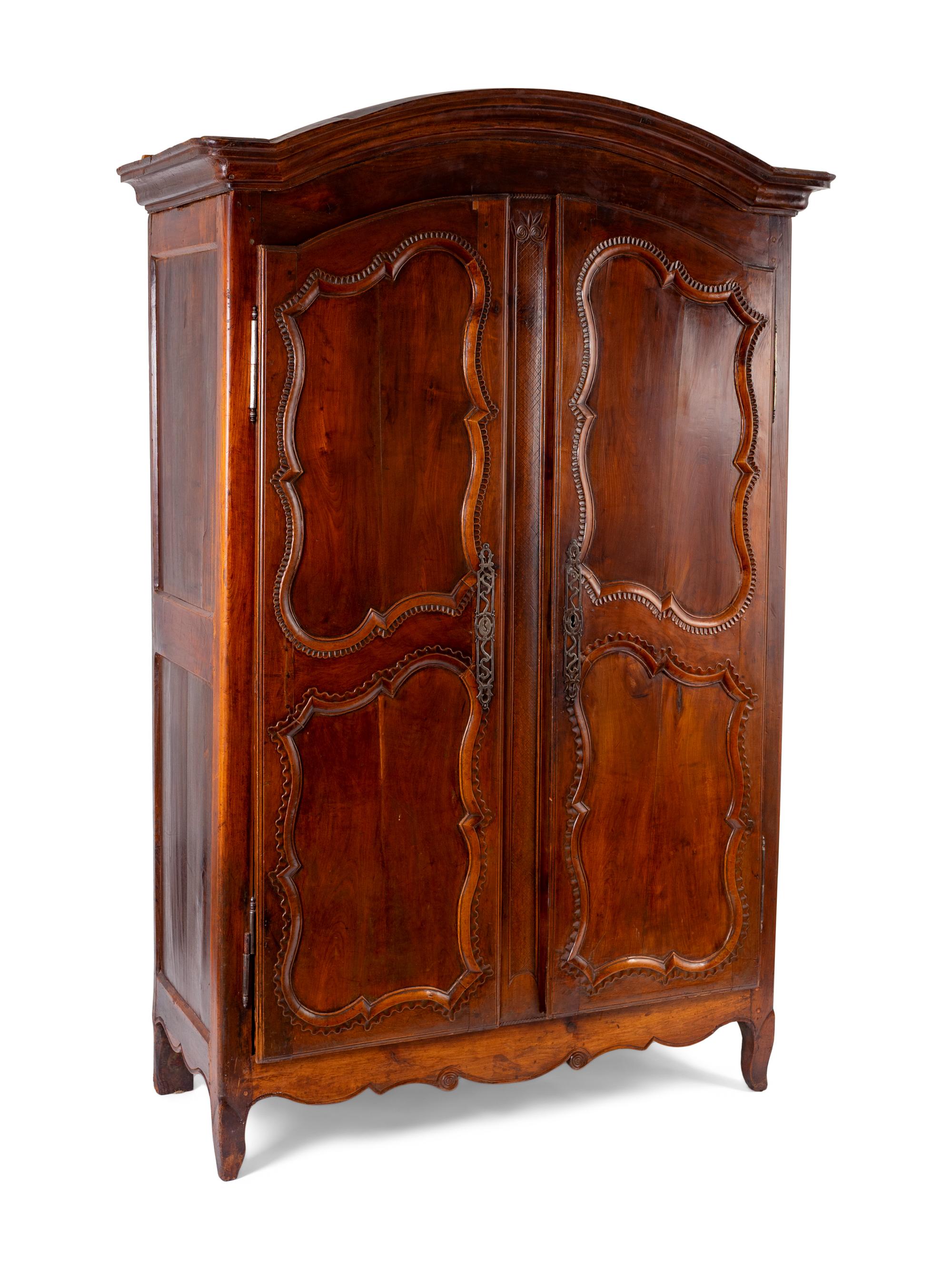 A French Provincial Carved Walnut Armoire — 19TH CENTURY