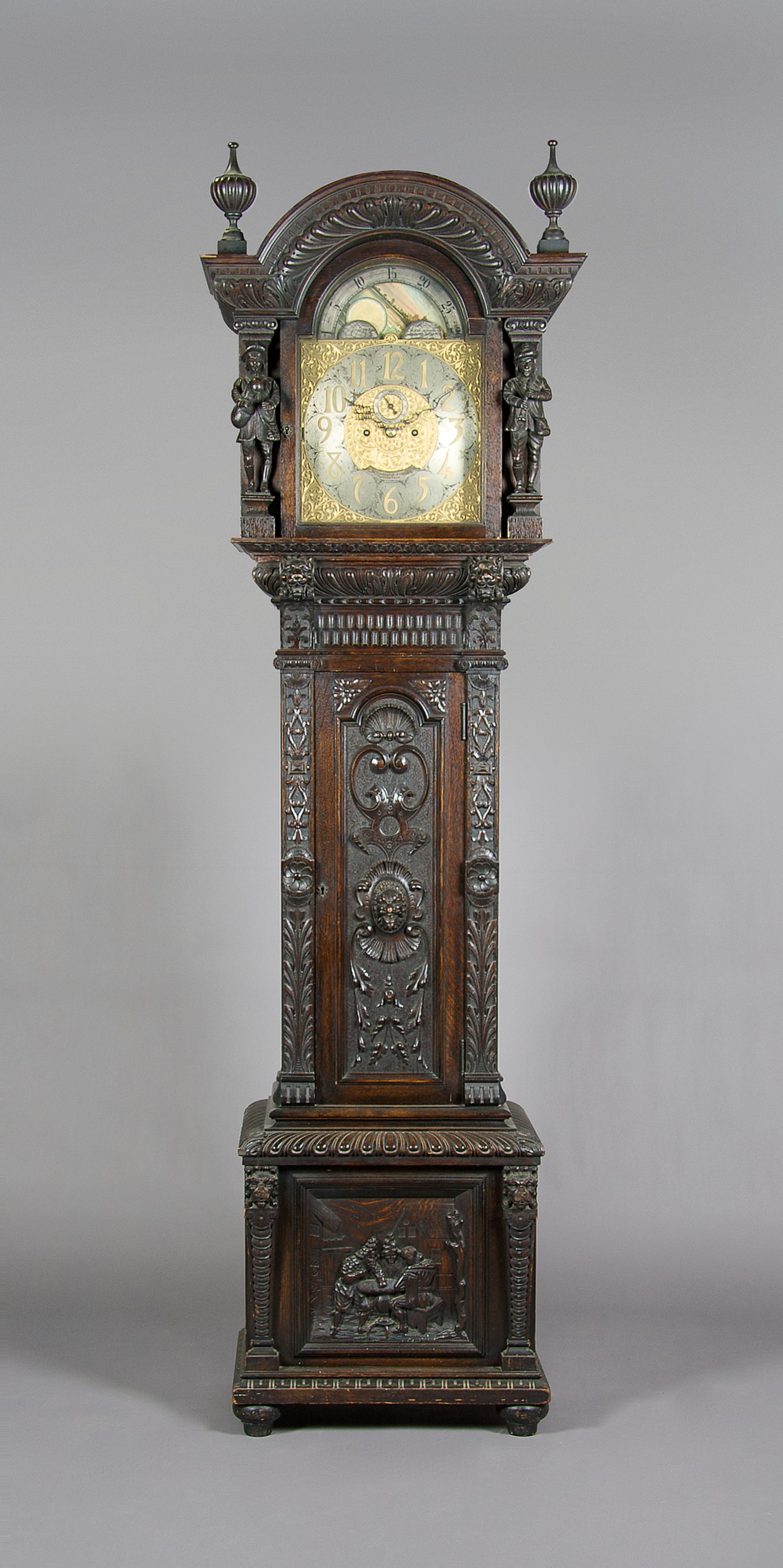 A Carved Oak Tall Case Clock, Elliot, London, Height 97 5/8 inches.