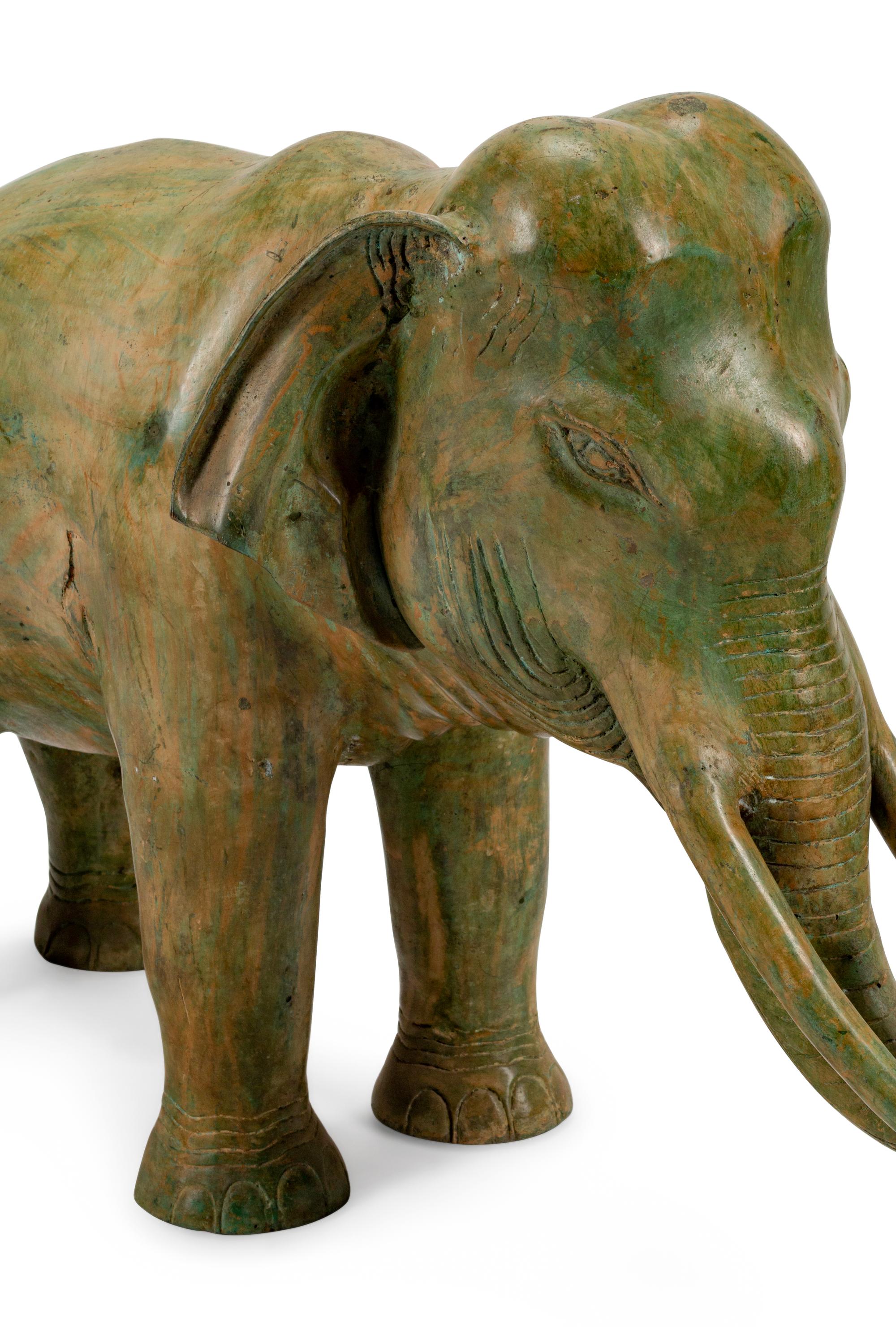 A Large Pair of Patinated Bronze Elephants