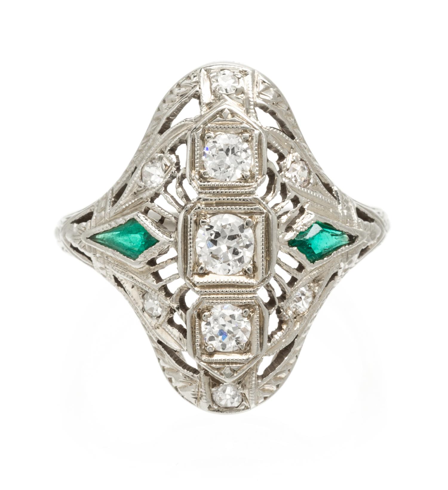 An 18 Karat White Gold, Diamond and Synthetic Emerald Ring, 3.20 dwts.