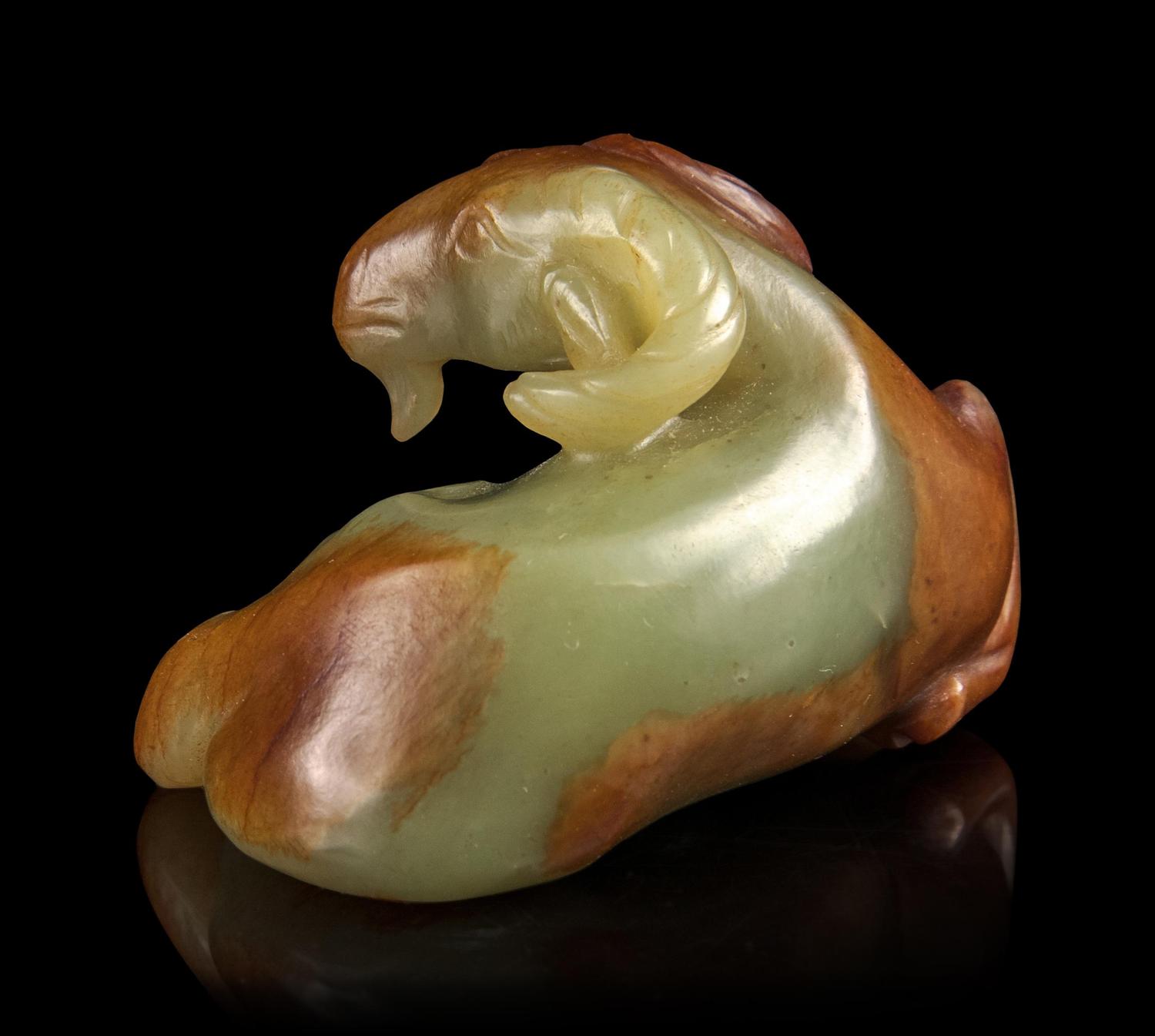 A Russet and White Jade Figure of a Ram