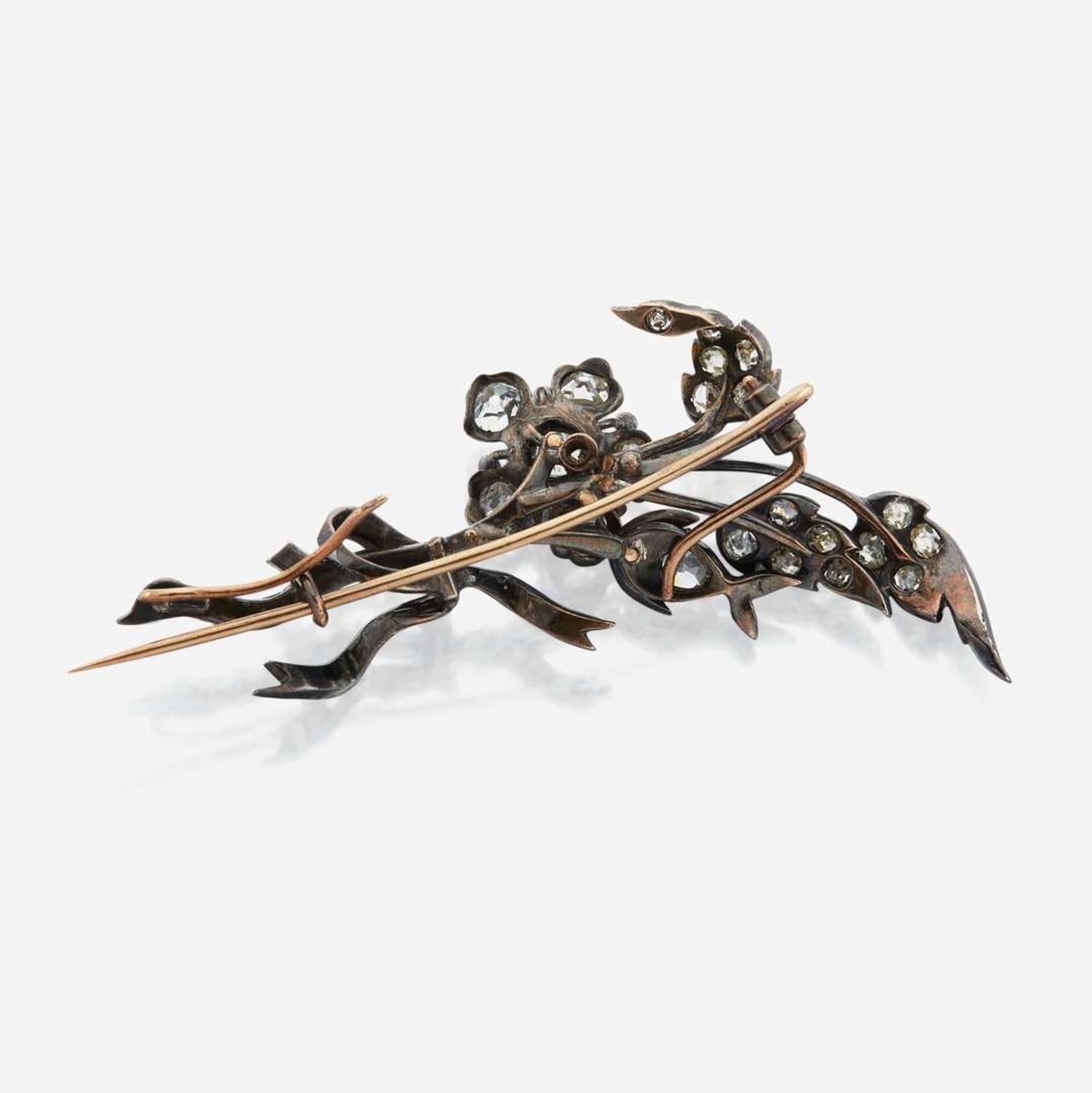 An antique diamond and silver topped gold brooch