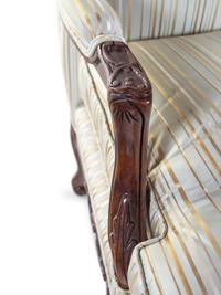 A Pair of Louis XV Style Carved Walnut Fauteuils
