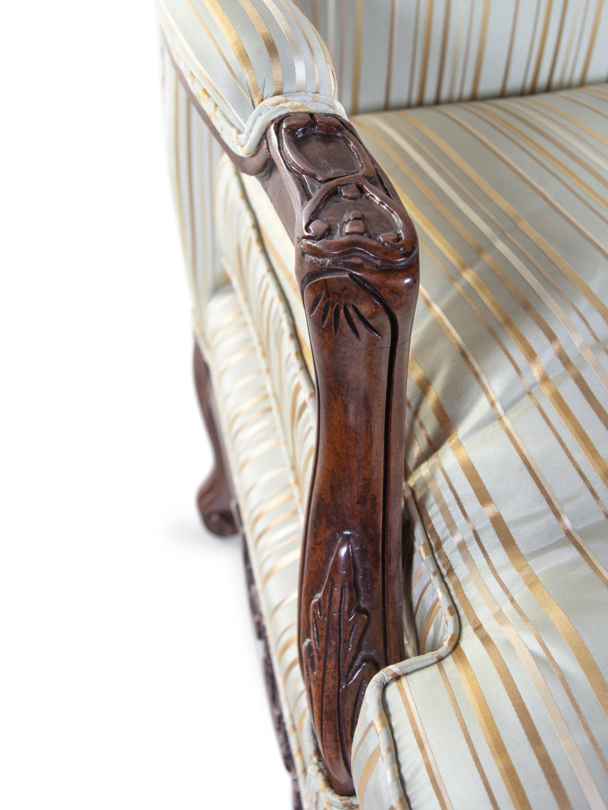 A Pair of Louis XV Style Carved Walnut Fauteuils