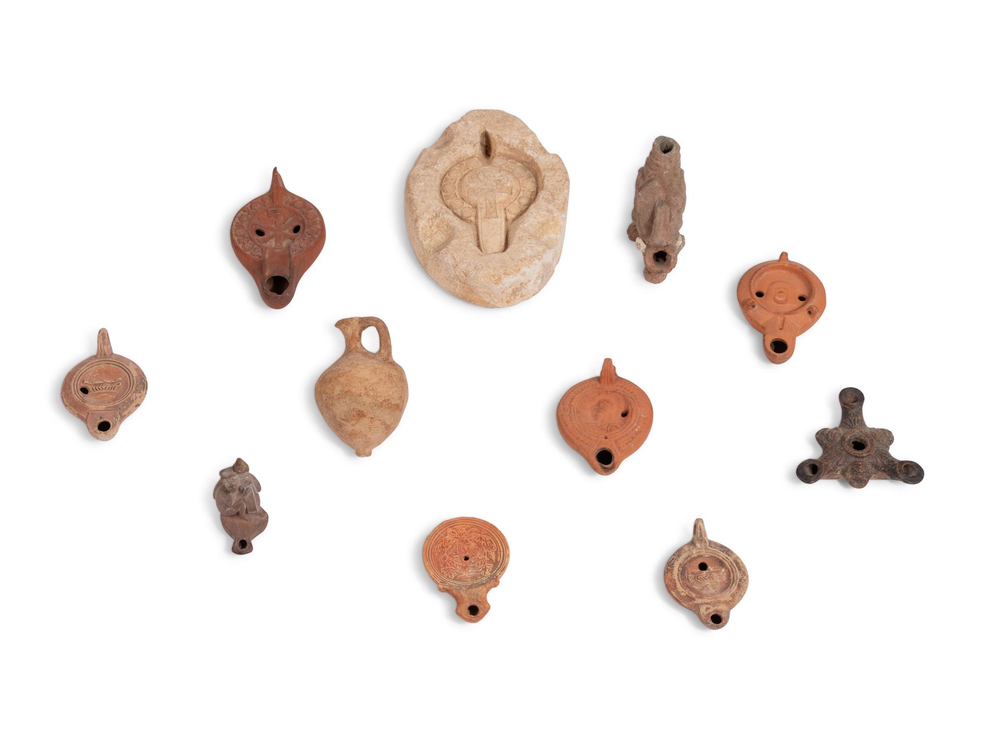 Ten Roman Terracotta Oil Lamps and a Holy Land Pottery Jug