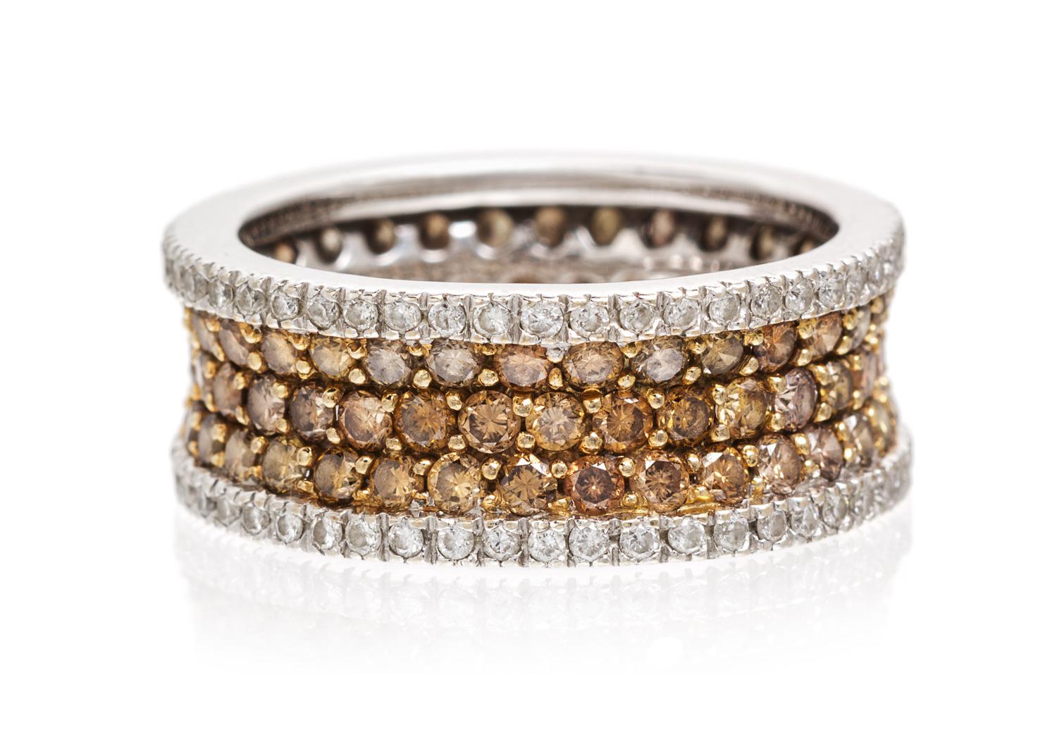 An 18 Karat White Gold, Colored Diamond and Diamond Eternity Band, 4.60 dwts.