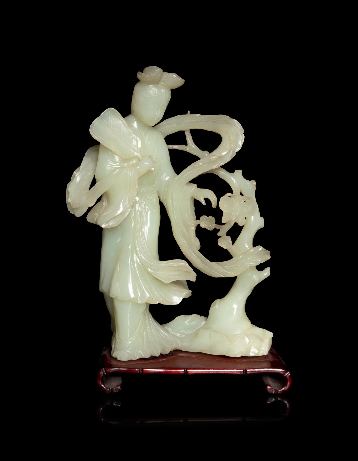 A Chinese Celadon Jade Figure of a Female Immortal