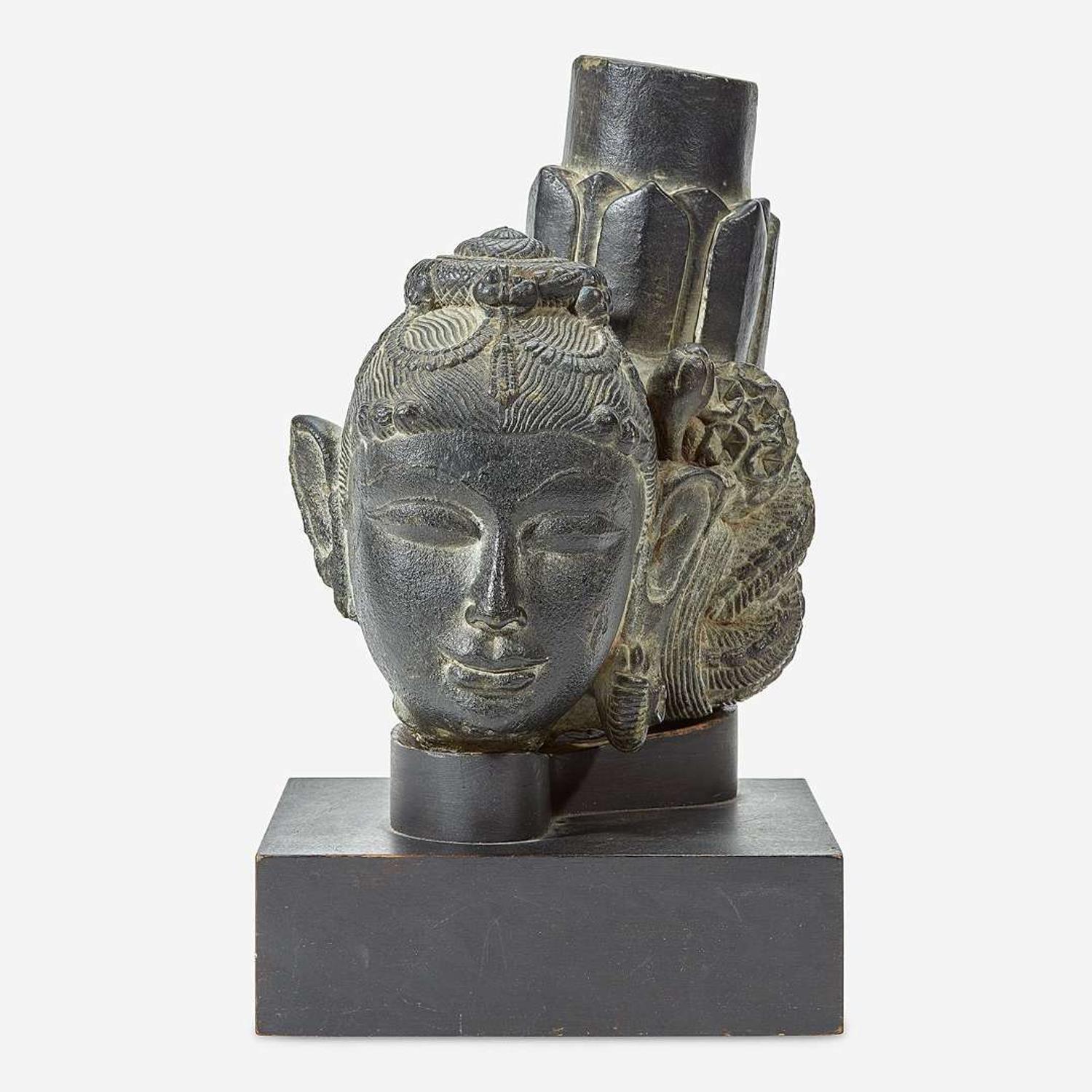 An Indian carved black stone head of a female Gahadavala Dynasty, 12th Century
