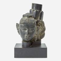 An Indian carved black stone head of a female Gahadavala Dynasty, 12th Century