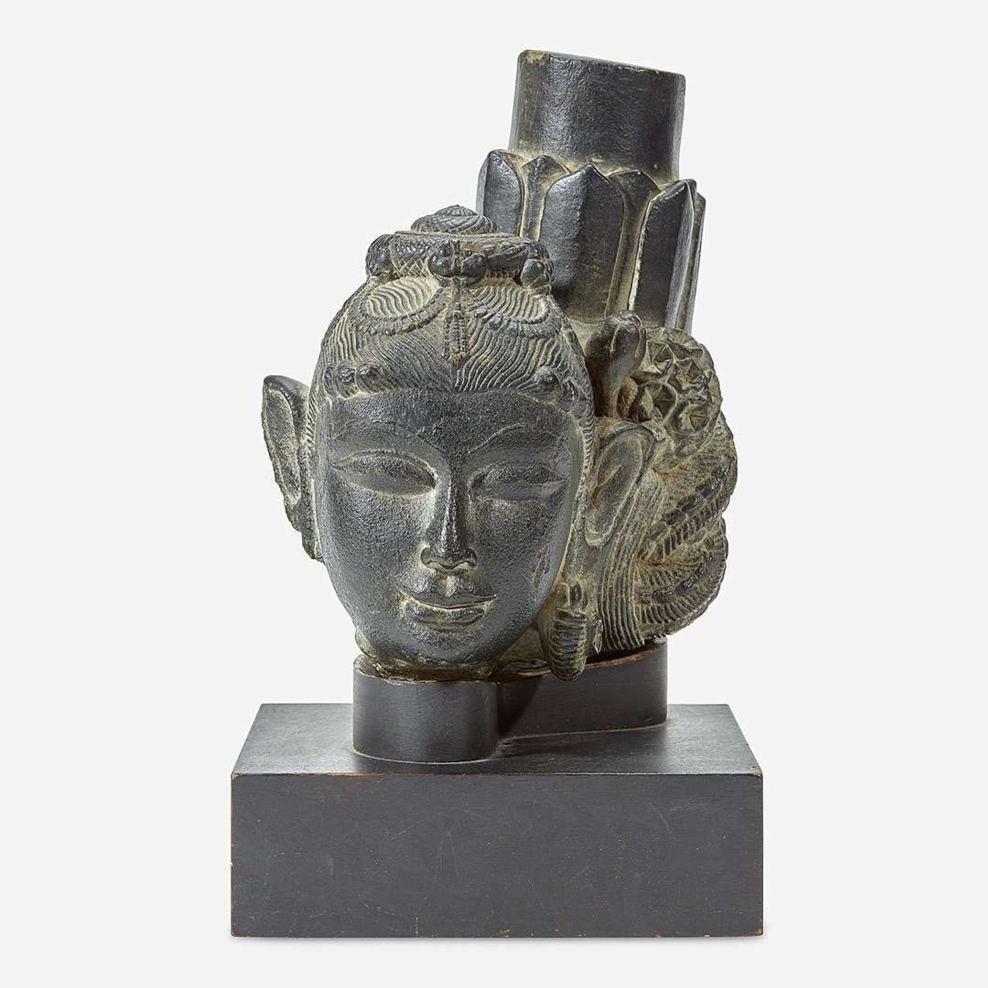An Indian carved black stone head of a female Gahadavala Dynasty, 12th Century