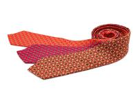 Three Hermes ties, two red, one khaki with orange pattern