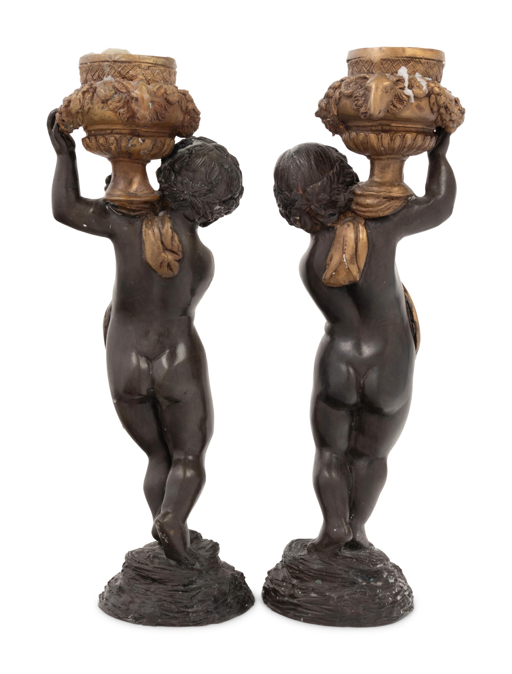 A Pair of Gilt and Patinated Bronze Figures of Cherubs