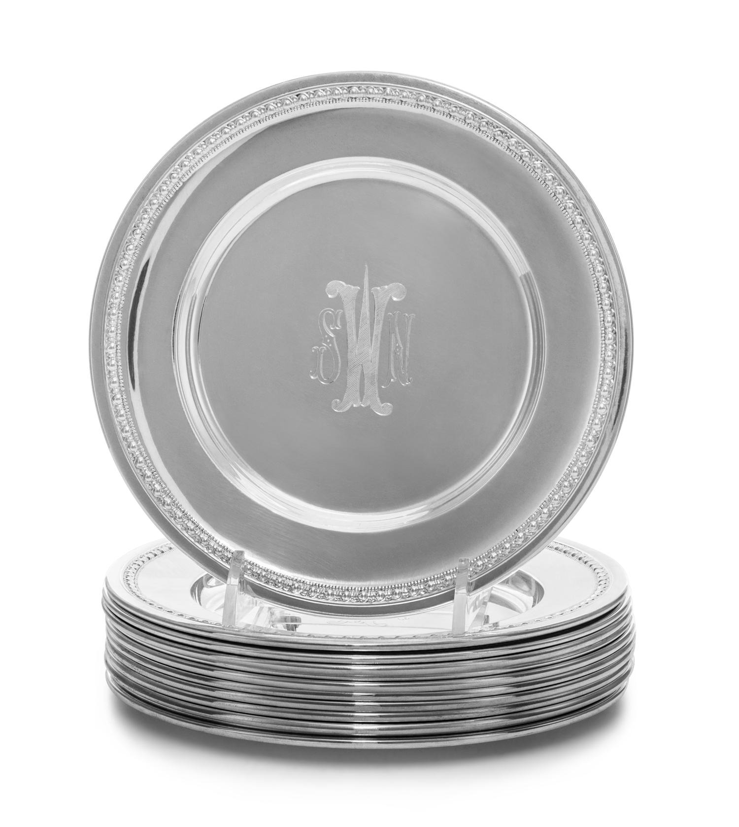 A Set of Twelve American Silver Bread Plates, 20th Century, each with an engraved SNW monogram at the center.