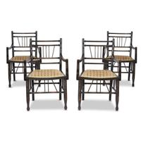 A set of four Arts & Crafts style ebonized 'Thebes' armchairs 20th century