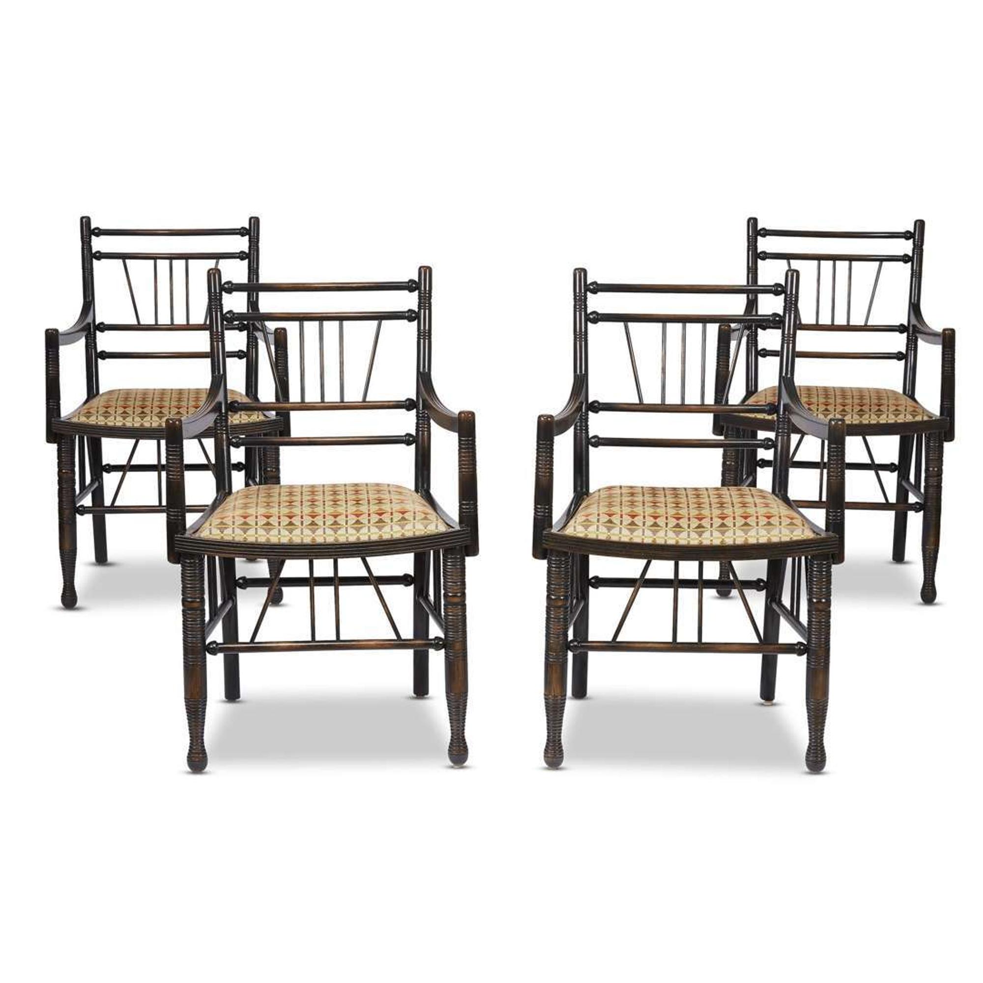 A set of four Arts & Crafts style ebonized 'Thebes' armchairs 20th century