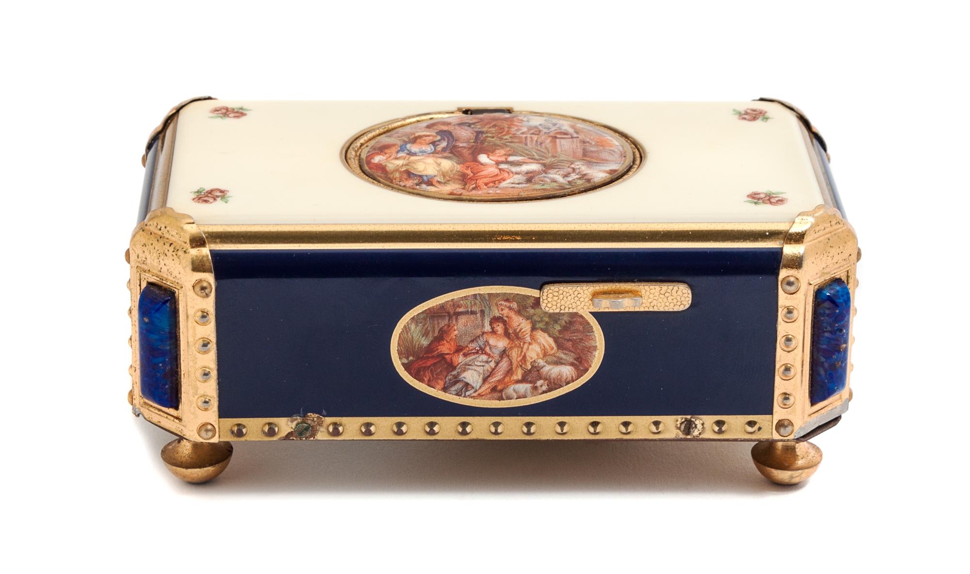 A Swiss Gilt Bronze and Enamel Music Box Length 4 7/8 inches. — 20TH CENTURY