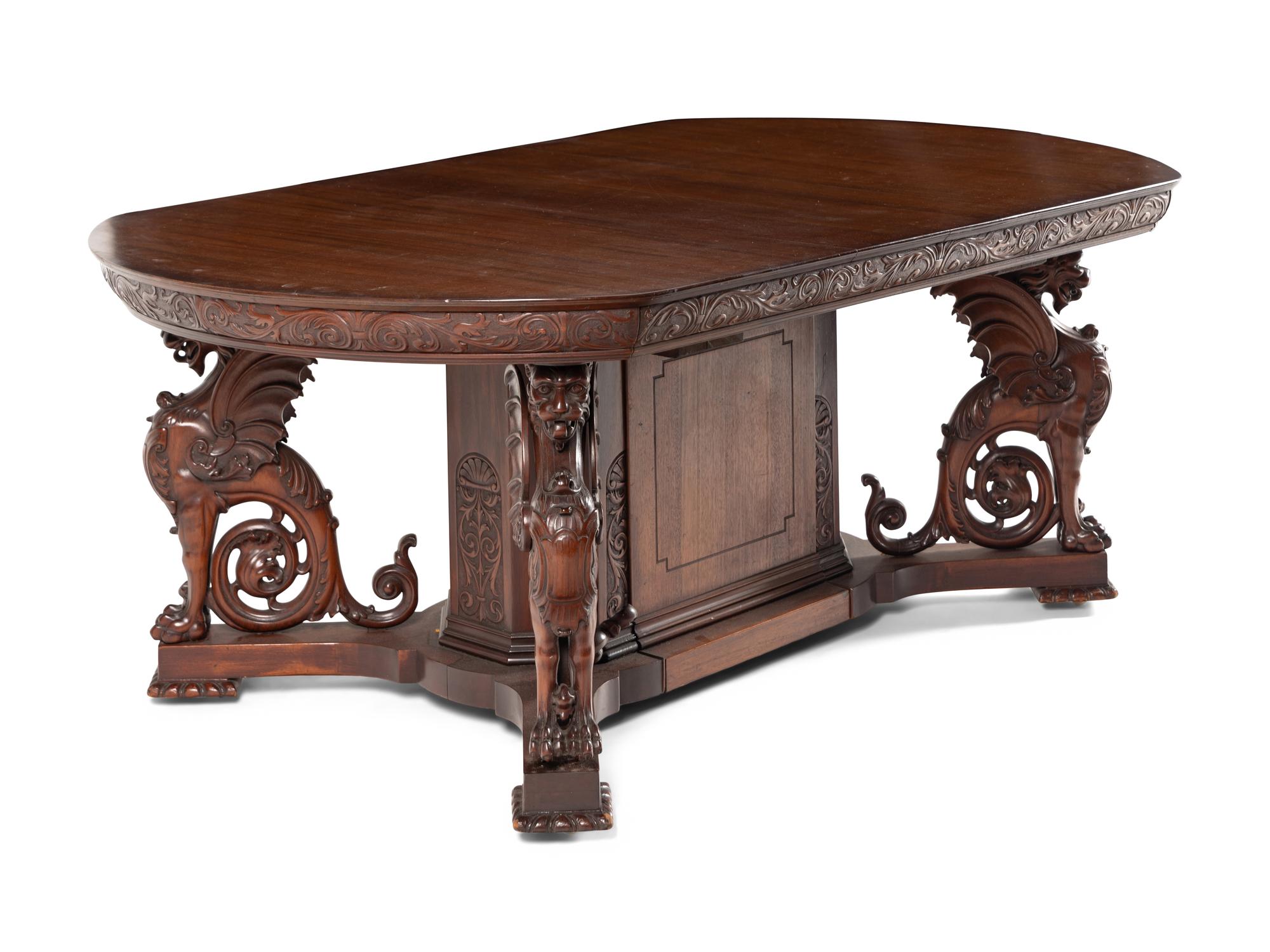 A Renaissance Revival Carved Mahogany Dining Table and Set of Six Chairs