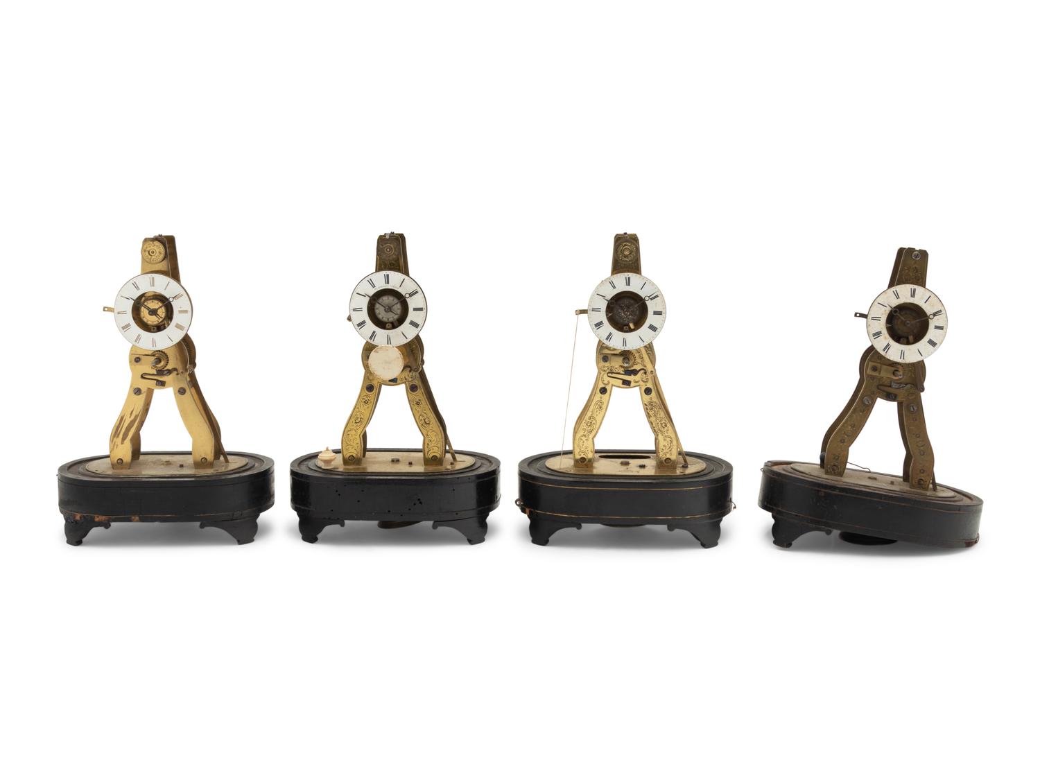 A Group of Four Brass Skeleton Clocks