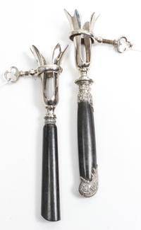 Two French Silver Mounted Bone Holders, makers' marks obscured, each having an ebony handle and a silvered metal clamp.