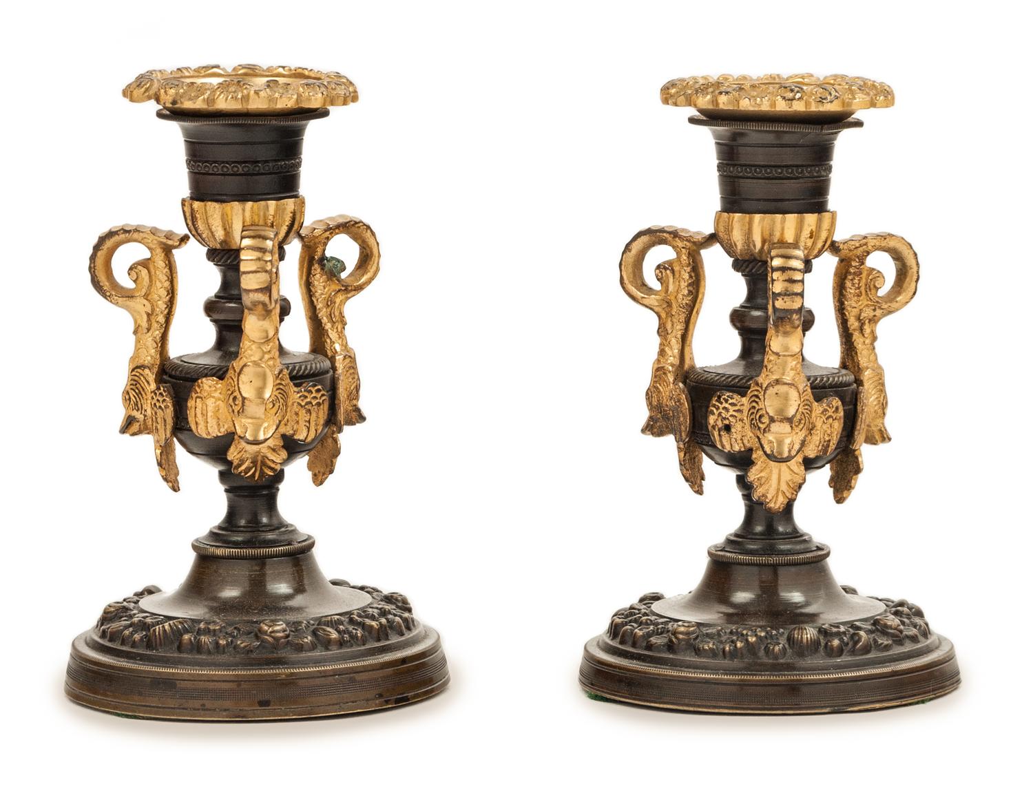 A Pair of Patinated and Gilt Bronze Candlesticks