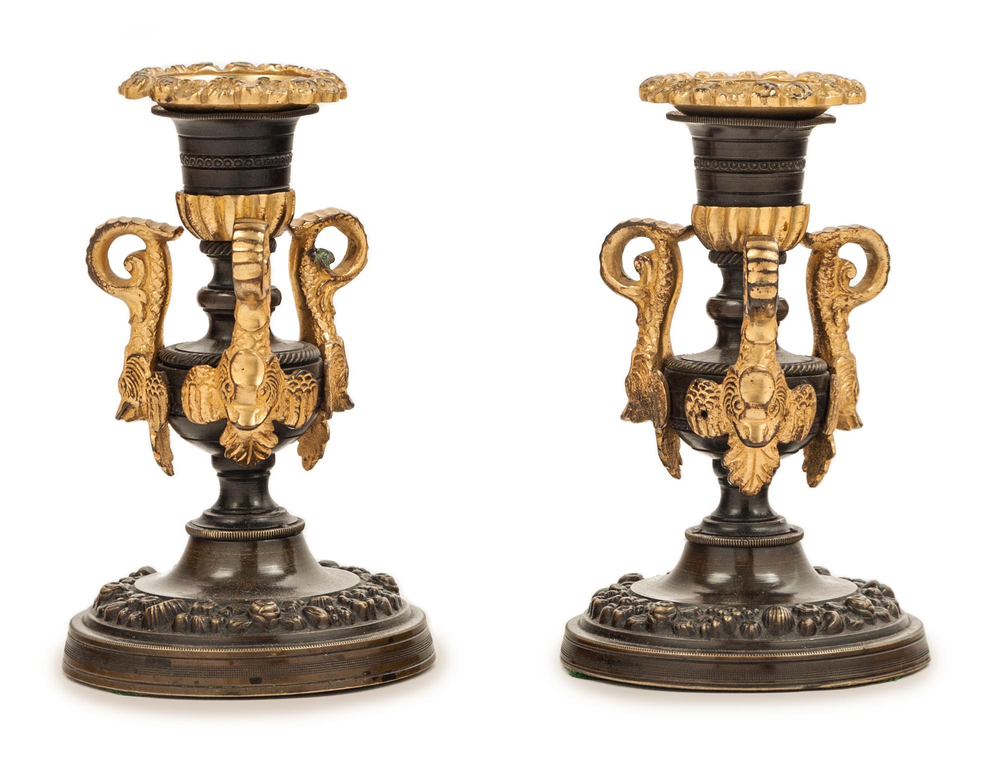 A Pair of Patinated and Gilt Bronze Candlesticks