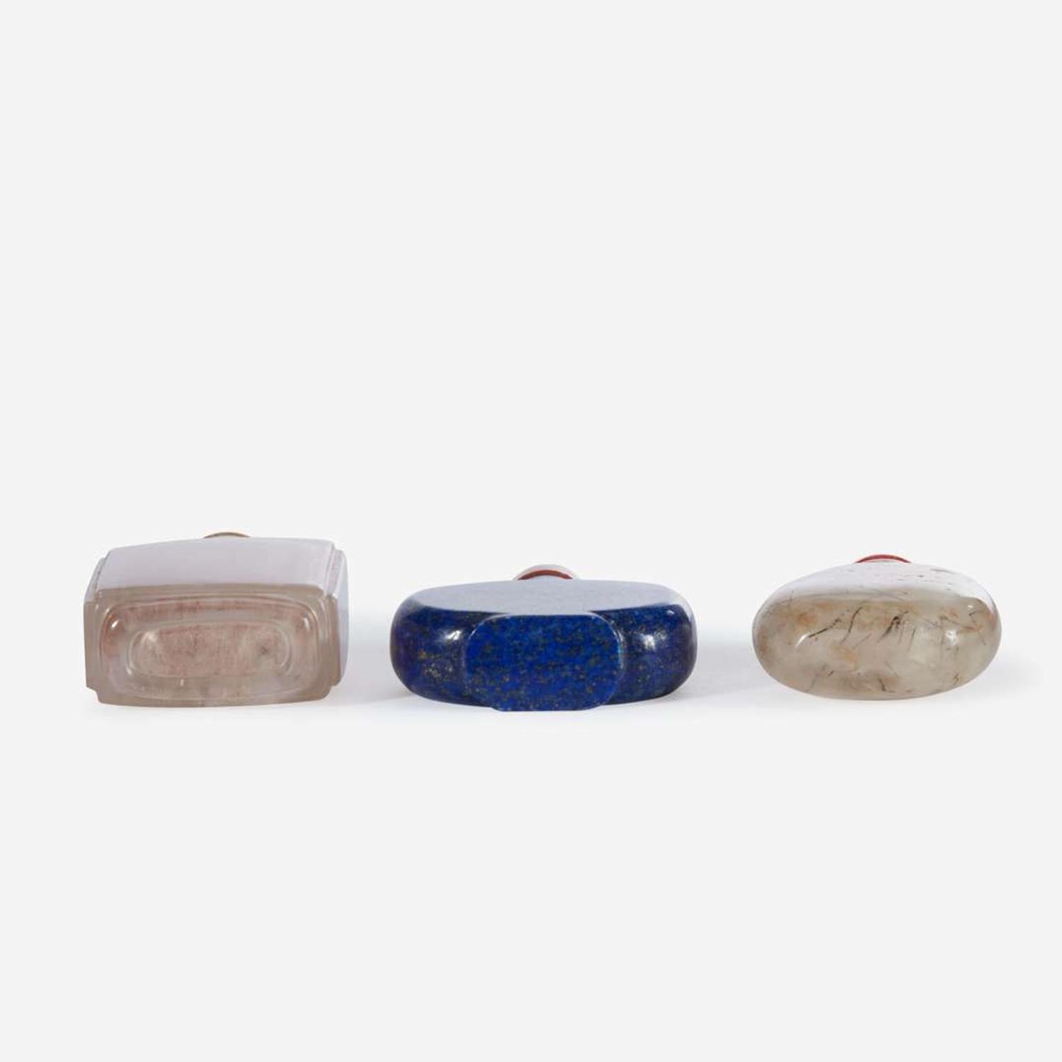 Two Chinese rock crystal snuff bottles and one lapis lazuli snuff bottle
