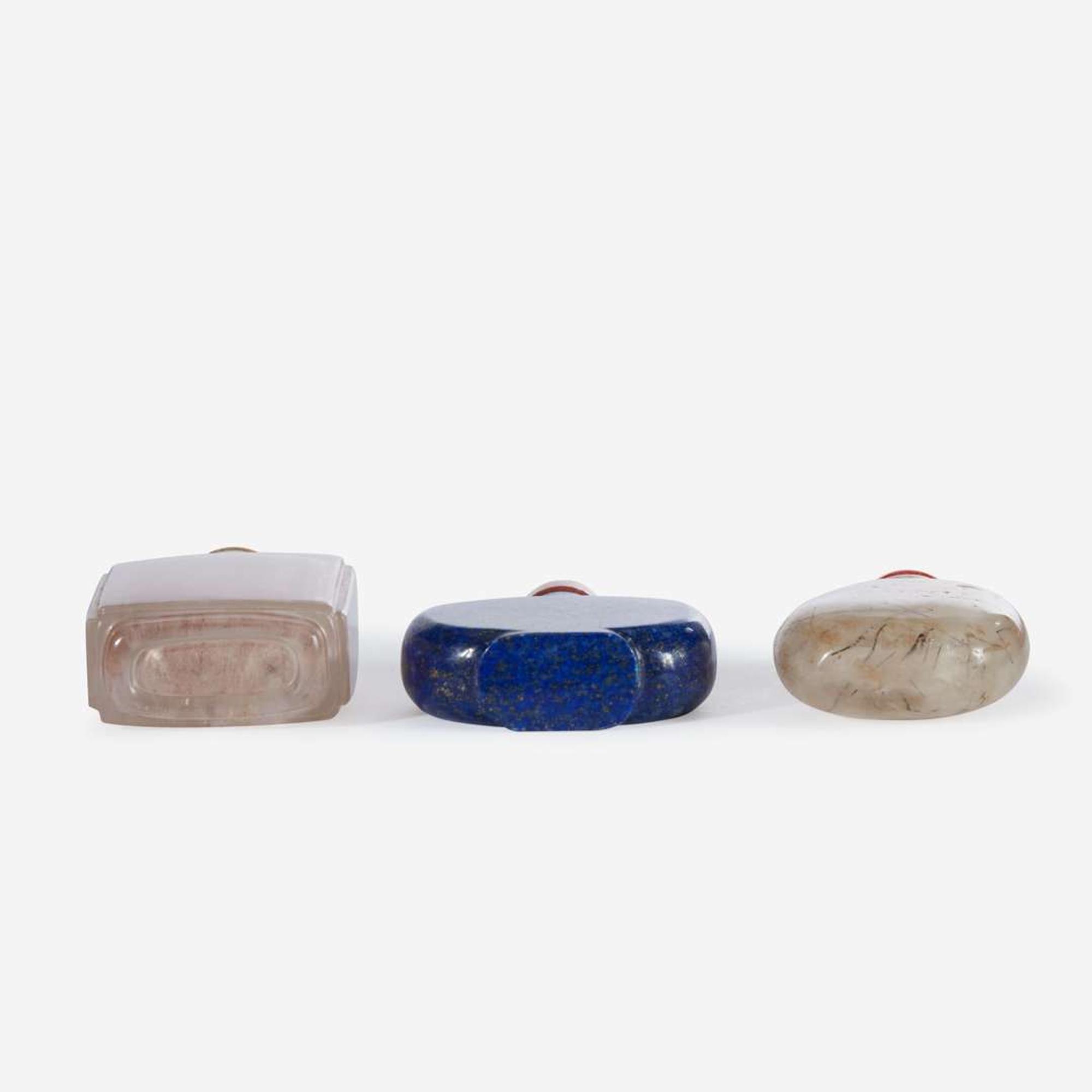 Two Chinese rock crystal snuff bottles and one lapis lazuli snuff bottle