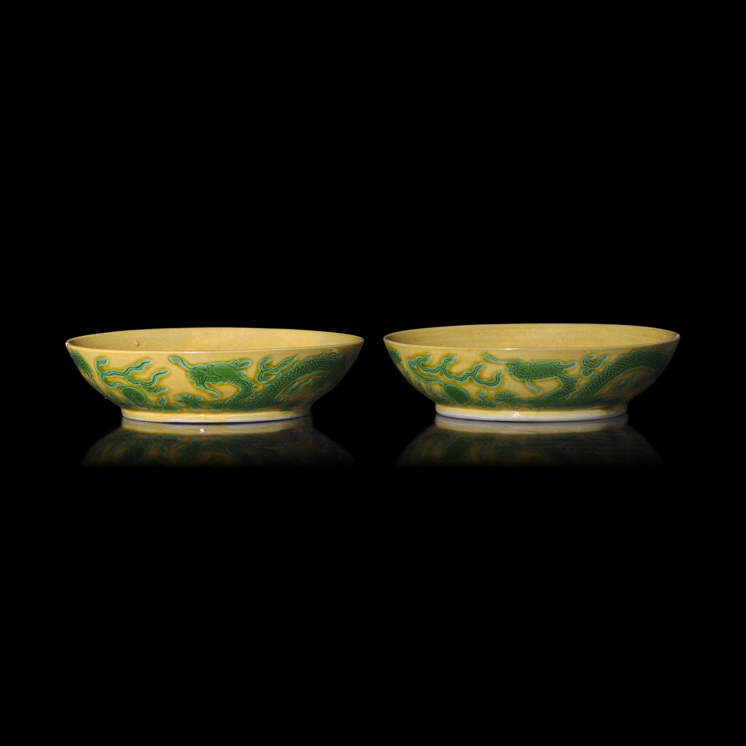 A Pair of Chinese Yellow Ground Green Enameled Porcelain 'Dragon' Dishes 黃地綠彩刻龍紋盤一對