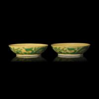 A Pair of Chinese Yellow Ground Green Enameled Porcelain 'Dragon' Dishes 黃地綠彩刻龍紋盤一對