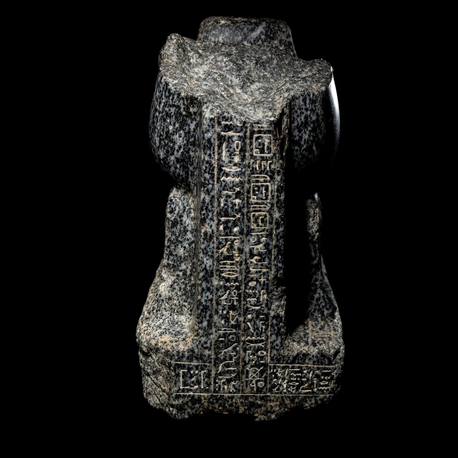 An Egyptian Gneiss Fragment of a Kneeling Figure