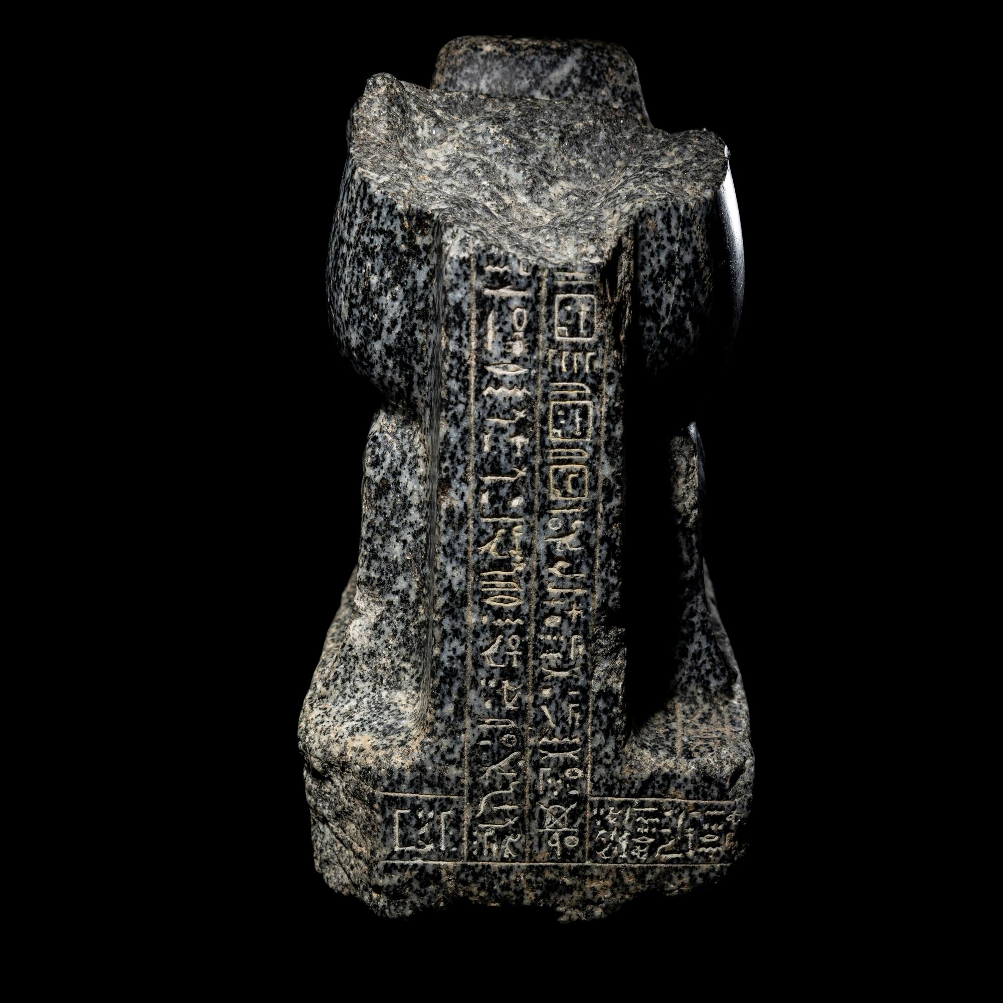 An Egyptian Gneiss Fragment of a Kneeling Figure