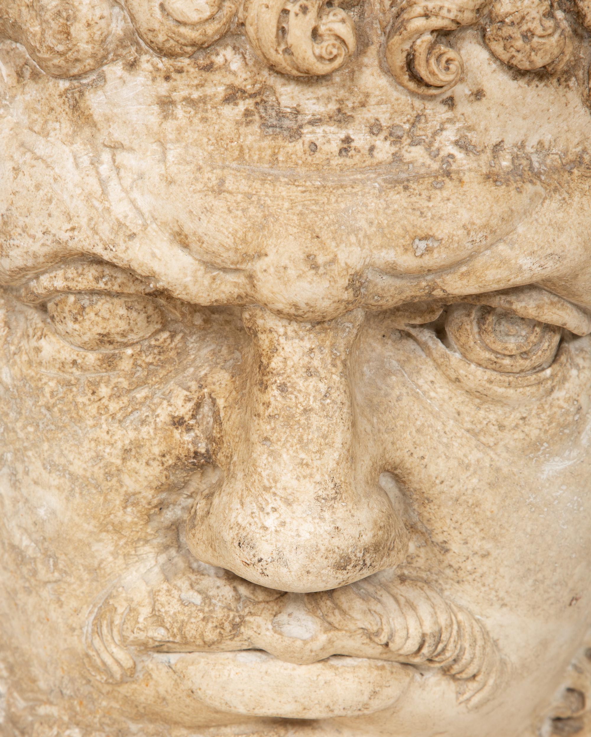 A Continental Carved Stone Head of a Man
