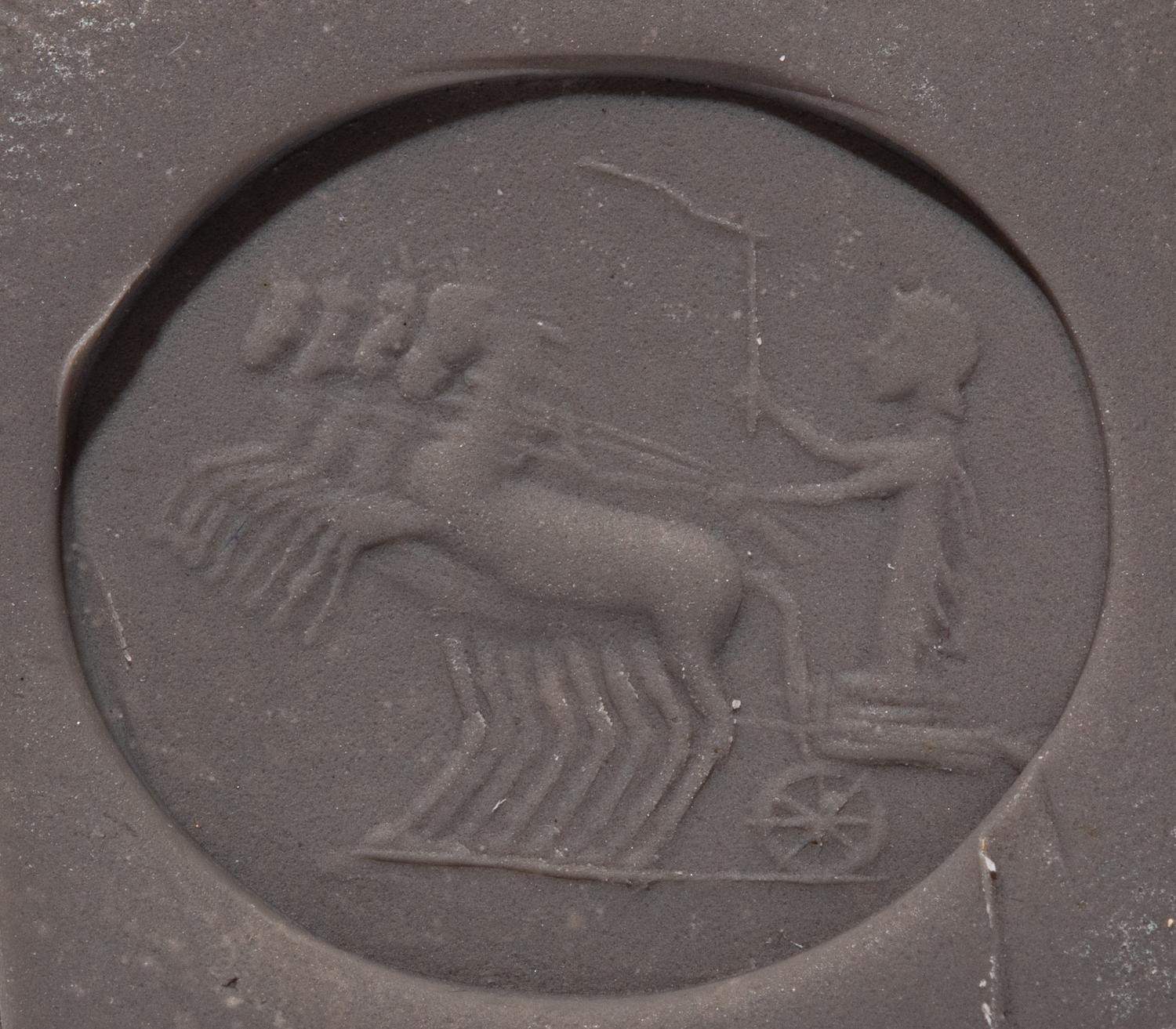 A Roman Chalcedony Ring Stone with a Charioteer Driving a Quadriga