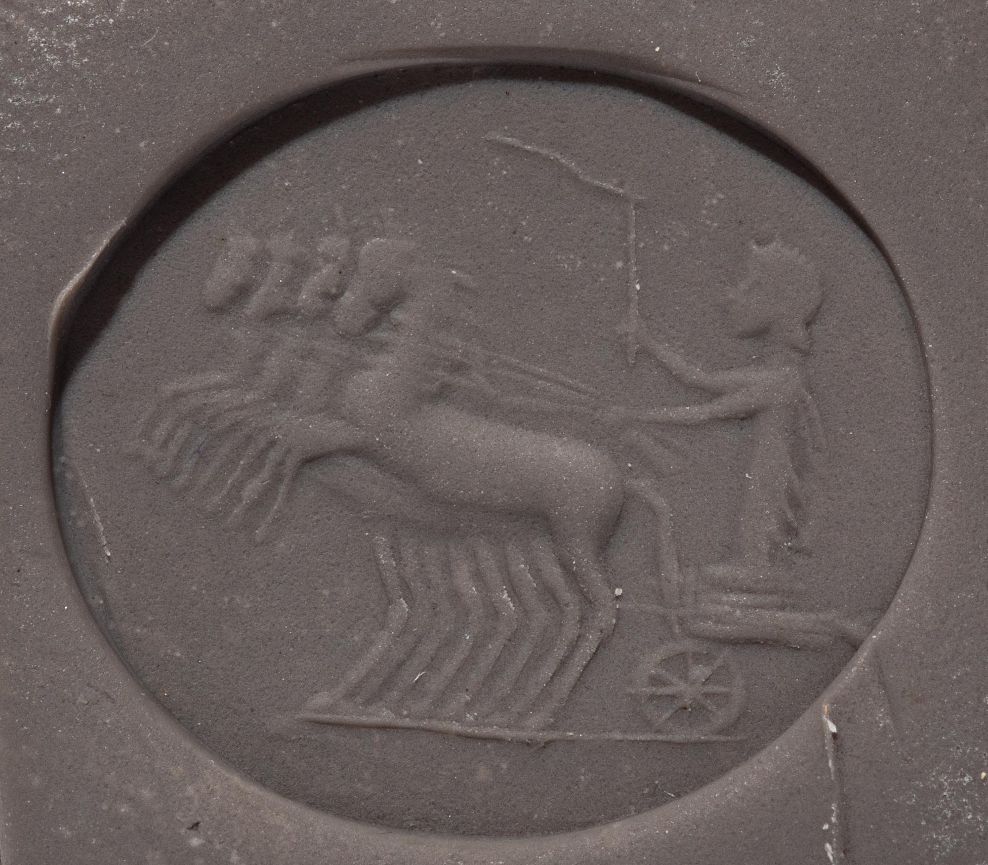 A Roman Chalcedony Ring Stone with a Charioteer Driving a Quadriga