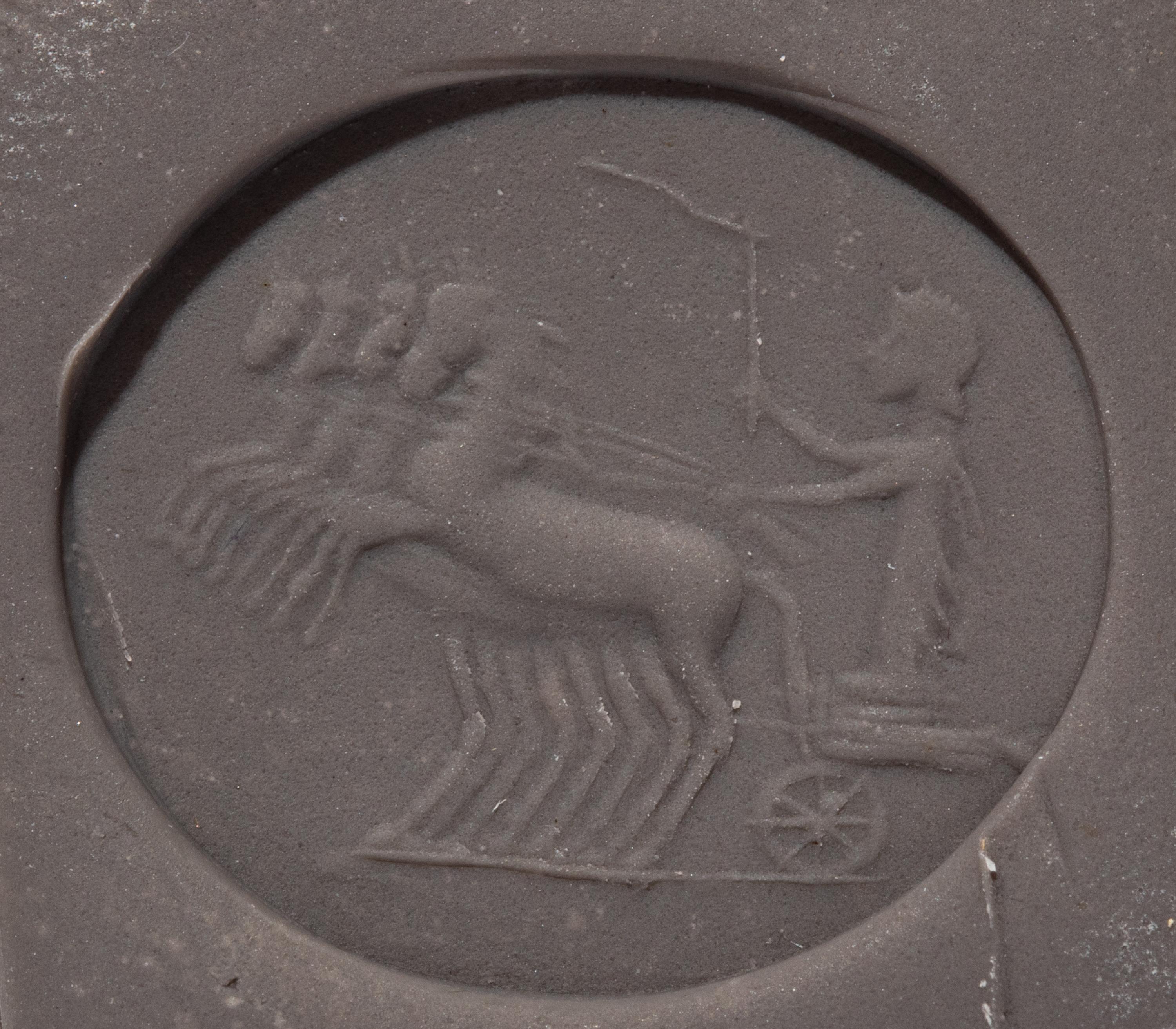 A Roman Chalcedony Ring Stone with a Charioteer Driving a Quadriga