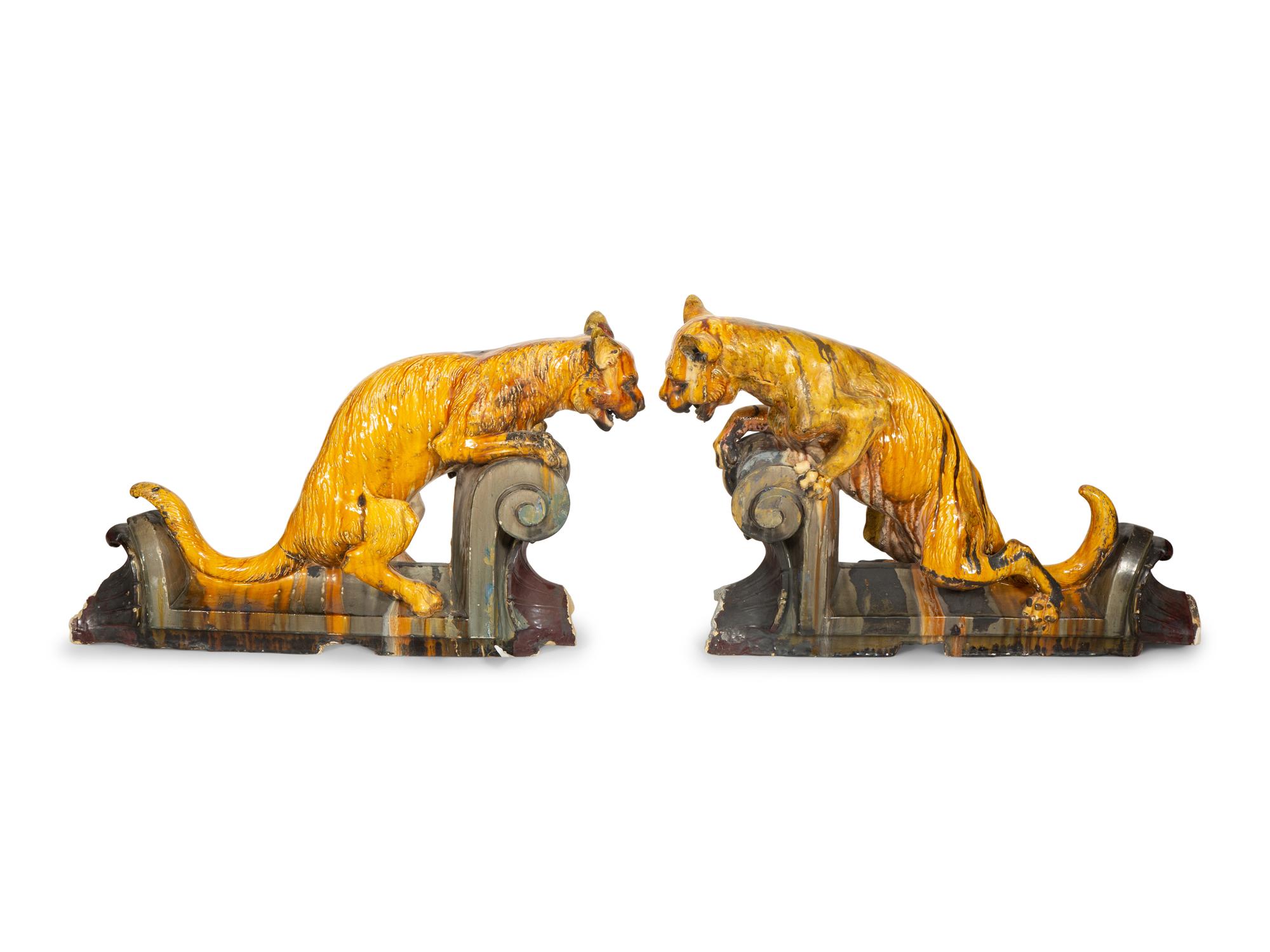 A Pair of Continental Glazed Terra Cotta Fox Roof Ornaments