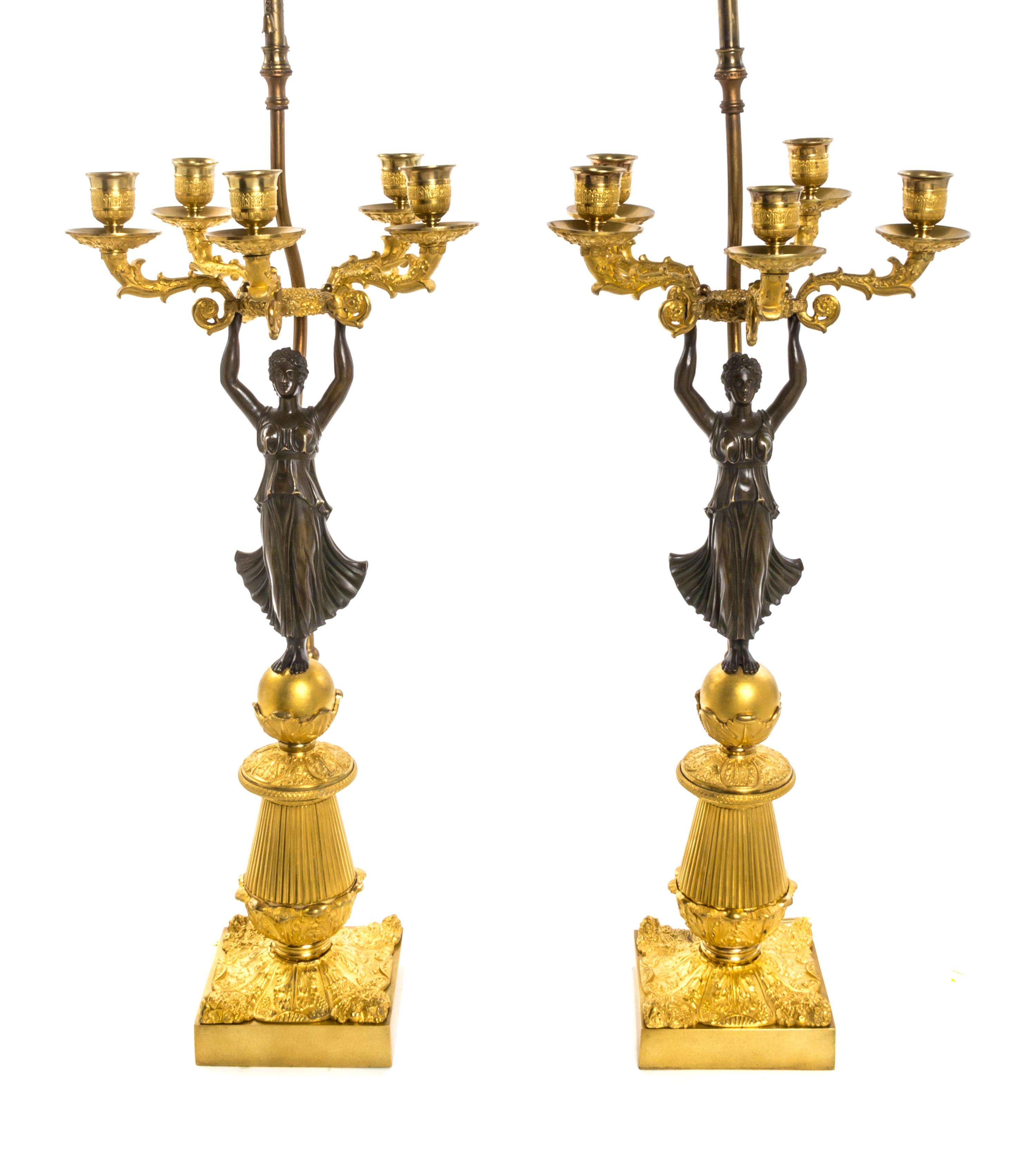 A Pair of Empire Gilt and Patinated Bronze Five-Light Figural Candelabra, Height 22 3/4 inches.
