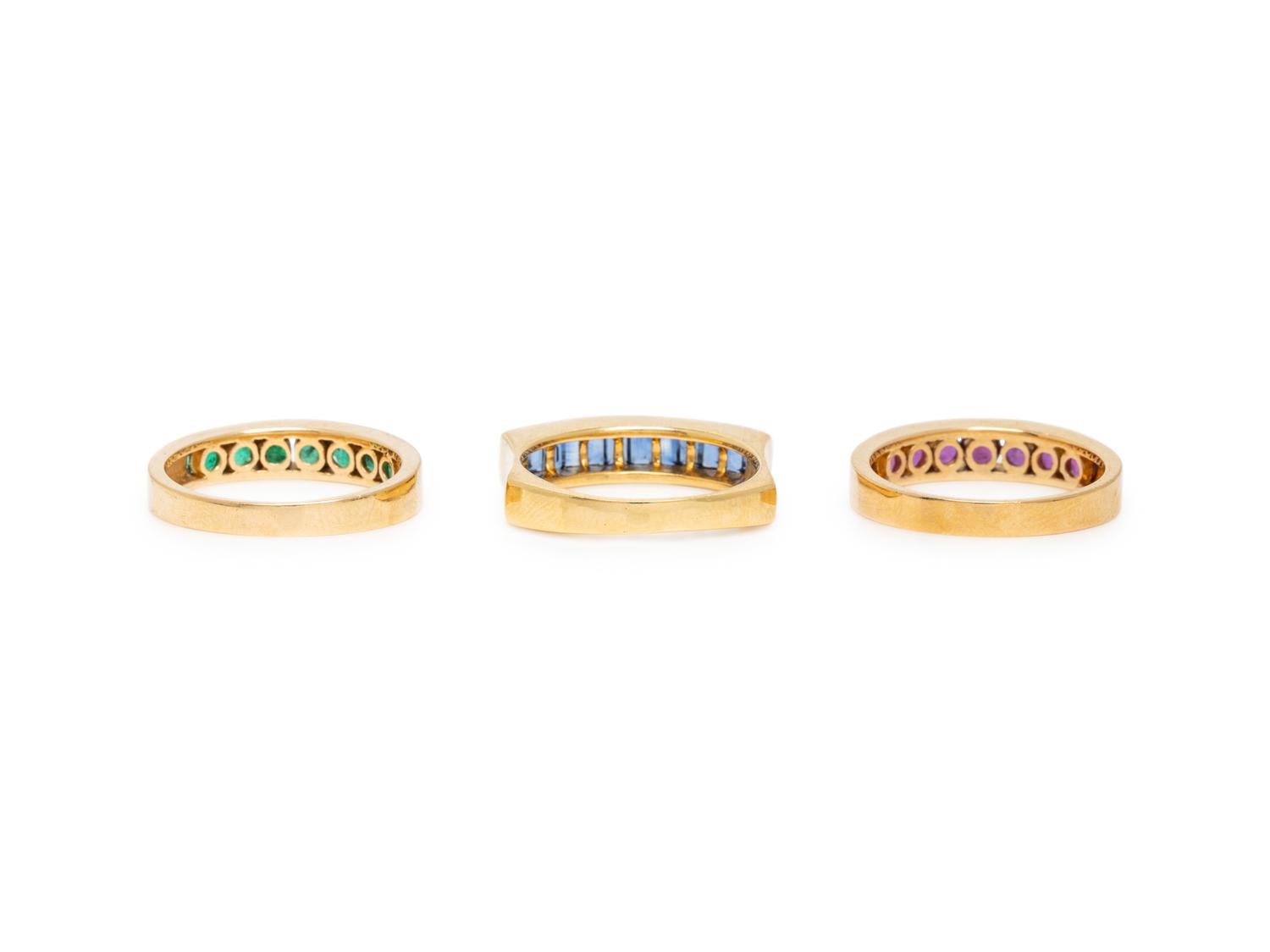 COLLECTION OF THREE RUBY, EMERALD, SAPPHIRE, AND YELLOW GOLD RINGS