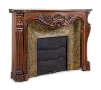 A Louis XV Style Carved Walnut and Pressed Gilt Metal Fireplace