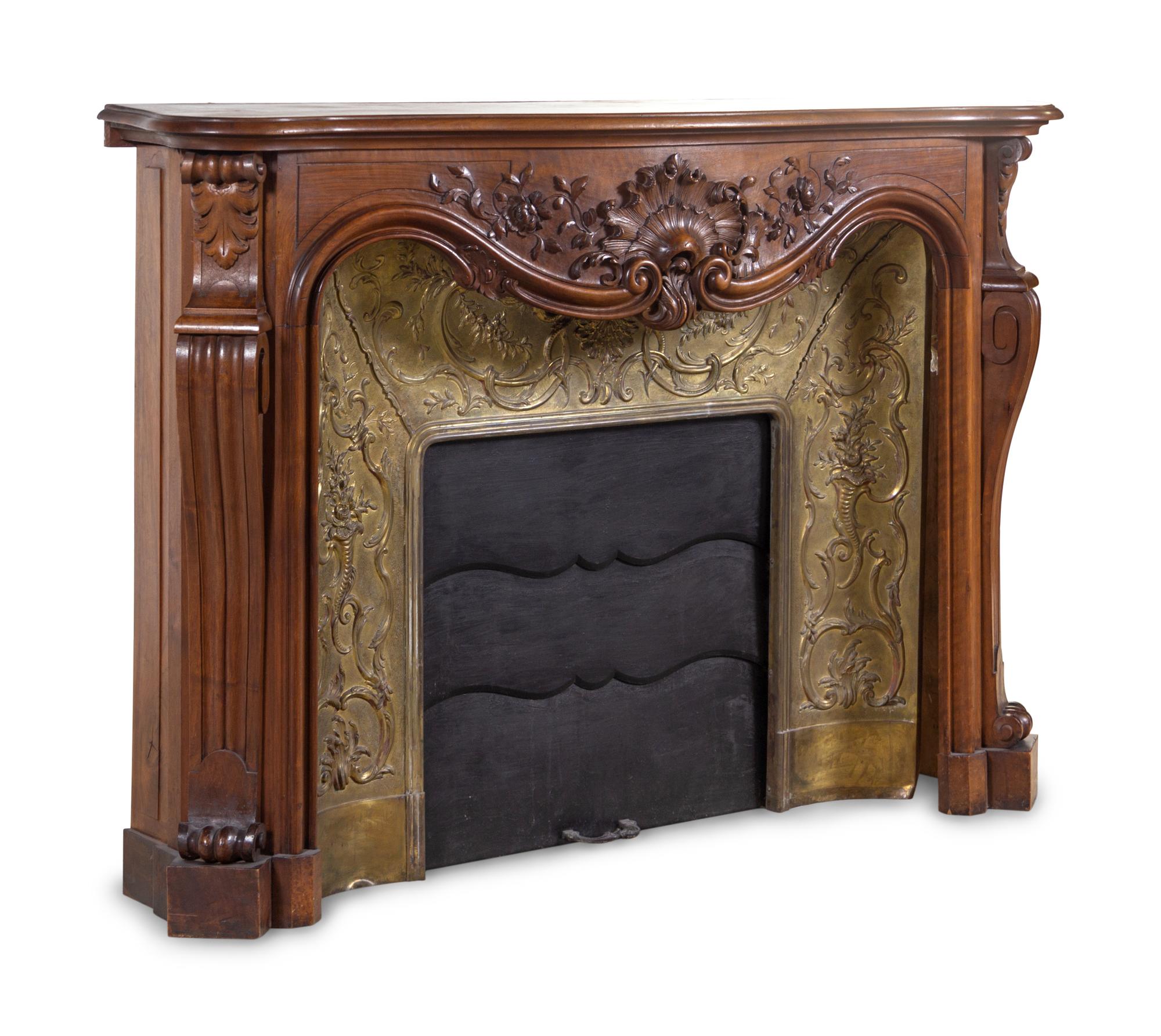 A Louis XV Style Carved Walnut and Pressed Gilt Metal Fireplace
